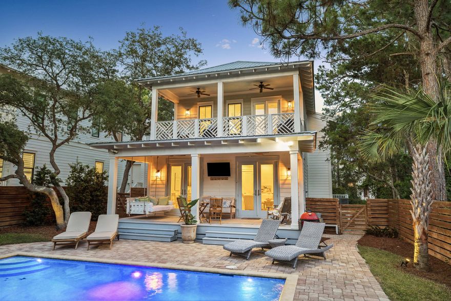 Welcome to 164 South Gulf Drive, a beautifully designed coastal residence tucked beneath a canopy of mature pines in the heart of Seagrove Beach. Blending timeless beach-house architecture with modern comfort, the home offers a refined yet relaxed lifestyle just moments from the Gulf of Mexico along the coveted Scenic Highway 30A corridor.

The light-filled interior features white-painted shiplap walls, wide-plank flooring, and an open-concept living area designed for effortless gathering and entertaining. The kitchen is appointed with custom cabinetry, quartz countertops, a generous center island, stainless steel appliances, and designer lighting that seamlessly connect to the main living and dining spaces. The primary suite offers a spa-inspired bath with dual vanities, a soaking tub, and a glass-enclosed shower, while additional guest accommodations include well-appointed bedrooms and a custom bunk room.

Outdoor living is centered around a private heated pool with paver decking and fully fenced grounds for added privacy. Covered porches, a hanging swing, and a second-level balcony overlooking the surrounding tree canopy create inviting spaces for relaxing and enjoying the coastal setting.

Additional highlights include a two-car garage and convenient access to nearby beach access points, dining, and shopping along 30A. Offered fully furnished, this residence is well-suited as a primary home, second residence, or investment opportunity.