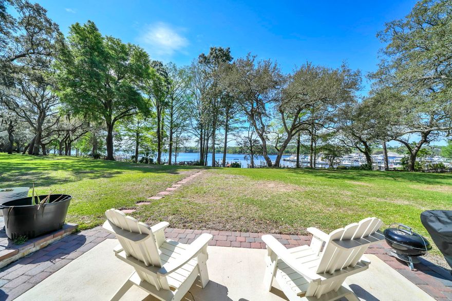Waterfront dreams do come true at 200 Regatta Dr located in the waterfront townhome community of Water Oaks in central Niceville. Nestled amongst majestic oaks, this 64-unit community offers unparallel views of Boggy Bayou as well as a private pool, tennis/pickleball/basketball court and waterfront gazebo. Keep your boat in your own back yard on a private deep-water dock (shared only by your neighbor) that comes with a boat lift. This home has been COMPLETELY updated by creating an open floorplan with a fantastic kitchen featuring granite counters and stainless appliances.  The kitchen leads to the roomy dining area and large living area overlooking the bayou. Upstairs you will find the master bedroom suite with a remodeled bath featuring a private balcony overlooking the back yard and bayou beyond. There are also 2 additional bedrooms upstairs, both leading to another private balcony and a large storage area. Outside, you will find a charming patio as well as a large deck offering STUNNING views. The dock is shared with the neighbor and offers a lift (on the right) for your boat as well. Now is the time to make your waterfront dreams come true today!!
