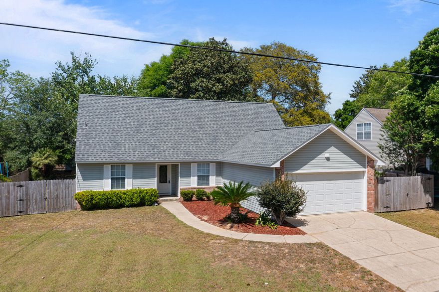 Discover a rare find in the heart of Crestview and embrace the Florida Lifestyle! 
This thoughtfully designed 4-bedroom, 3-bathroom home features not one, but two primary suites, offering incredible flexibility for multi-generational living, a long-term guest wing, or a private home office setup. The open-concept living area boasts a cozy fireplace and flows seamlessly into a bright kitchen and dining space.  Bedrooms have new carpet. Living areas and bathrooms have tile flooring~ Heading out back a spacious Florida room, perfect for sipping your morning coffee while overlooking the massive, privacy-fenced backyard.
 
Roof - 2024; AC per manuf. date is 2014; Water Heater per manuf. is 2017

Don't miss this charming property