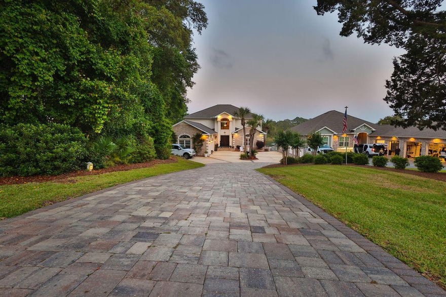 There are homes that simply meet expectations--and then there are homes where every line, every material, and every space reflects intention. This is one of those rare residences.

Crafted by an owner with a deep reverence for the water, for family, and for living fully, this custom-built estate carries a level of detail that is rarely delivered. Rich wood floors with intricate inlays, a masterfully detailed wood ceiling, and a one-of-a-kind custom bar--sculpted in the likeness of a sportfishing yacht's stern--bring the soul of the open water indoors with striking authenticity.

Positioned along a natural slope--an uncommon advantage in Florida--the home offers a true walkout basement design. This allows for effortless, single-level living on the main floor with a grand entertaining space and primary suite, while still capturing elevated, commanding views typically reserved for multi-story climbs.

The main level is anchored by a spacious custom kitchen and an open, flowing layout designed for gathering. Below, the walkout level transforms into a private bayou lodge retreat--rich with pecky cypress accents, a unique yacht bar also molded into the feeling of a classic English pub, and an expansive game and entertainment space centered around a stone fireplace. In a final touch of creativity, a custom-built thatched-roof hut encloses the full bath and utility space--an unexpected, artful nod to faraway escapes. Large windows and built-in window seats frame serene views over the pool deck and across the bayou.

Set on the protected waters of Poquito Bayou--known among experienced boaters as a premier "hurricane hole"--the property offers calm, deepwater access ideal for boating, fishing, and watersports. A robust dock and a thoughtfully designed brick-paver path allow for easy transport of gear from home to water, whether by foot, cart, or golf cart.

The upper level provides a private haven for family and guests, with generously sized rooms, expansive balconies, and sweeping views that feel as though you're perched several stories above the bayou--thanks to the home's elevated positioning.

This is more than a home--it's a yachtsman's sanctuary designed for those who value craftsmanship, connection, and a life well-lived. A place where days are measured in time on the water, evenings in shared stories, and every detail supports a life fully experienced.

Because with a property like this, you're not just investing in real estate--you're investing in a legacy.

Beyond just right, it's livin' right.