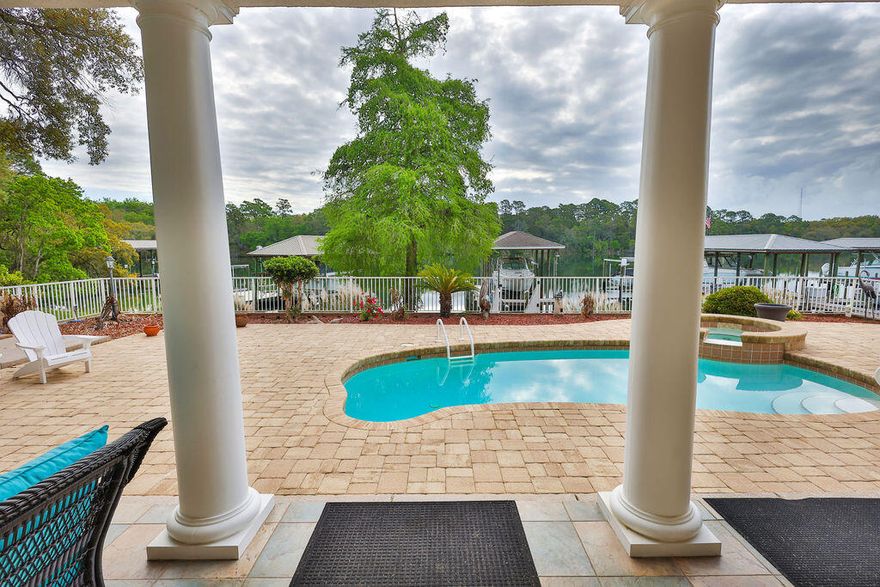 There are homes that simply meet expectations--and then there are homes where every line, every material, and every space reflects intention. This is one of those rare residences.

Crafted by an owner with a deep reverence for the water, for family, and for living fully, this custom-built estate carries a level of detail that is rarely delivered. Rich wood floors with intricate inlays, a masterfully detailed wood ceiling, and a one-of-a-kind custom bar--sculpted in the likeness of a sportfishing yacht's stern--bring the soul of the open water indoors with striking authenticity.

Positioned along a natural slope--an uncommon advantage in Florida--the home offers a true walkout basement design. This allows for effortless, single-level living on the main floor with a grand entertaining space and primary suite, while still capturing elevated, commanding views typically reserved for multi-story climbs.

The main level is anchored by a spacious custom kitchen and an open, flowing layout designed for gathering. Below, the walkout level transforms into a private bayou lodge retreat--rich with pecky cypress accents, a unique yacht bar also molded into the feeling of a classic English pub, and an expansive game and entertainment space centered around a stone fireplace. In a final touch of creativity, a custom-built thatched-roof hut encloses the full bath and utility space--an unexpected, artful nod to faraway escapes. Large windows and built-in window seats frame serene views over the pool deck and across the bayou.

Set on the protected waters of Poquito Bayou--known among experienced boaters as a premier "hurricane hole"--the property offers calm, deepwater access ideal for boating, fishing, and watersports. A robust dock and a thoughtfully designed brick-paver path allow for easy transport of gear from home to water, whether by foot, cart, or golf cart.

The upper level provides a private haven for family and guests, with generously sized rooms, expansive balconies, and sweeping views that feel as though you're perched several stories above the bayou--thanks to the home's elevated positioning.

This is more than a home--it's a yachtsman's sanctuary designed for those who value craftsmanship, connection, and a life well-lived. A place where days are measured in time on the water, evenings in shared stories, and every detail supports a life fully experienced.

Because with a property like this, you're not just investing in real estate--you're investing in a legacy.

Beyond just right, it's livin' right.