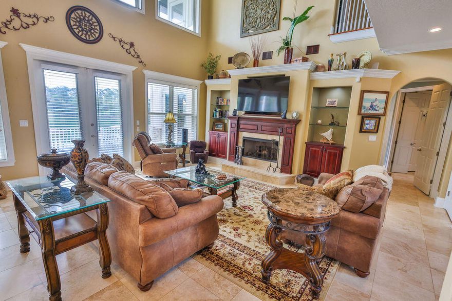 There are homes that simply meet expectations--and then there are homes where every line, every material, and every space reflects intention. This is one of those rare residences.

Crafted by an owner with a deep reverence for the water, for family, and for living fully, this custom-built estate carries a level of detail that is rarely delivered. Rich wood floors with intricate inlays, a masterfully detailed wood ceiling, and a one-of-a-kind custom bar--sculpted in the likeness of a sportfishing yacht's stern--bring the soul of the open water indoors with striking authenticity.

Positioned along a natural slope--an uncommon advantage in Florida--the home offers a true walkout basement design. This allows for effortless, single-level living on the main floor with a grand entertaining space and primary suite, while still capturing elevated, commanding views typically reserved for multi-story climbs.

The main level is anchored by a spacious custom kitchen and an open, flowing layout designed for gathering. Below, the walkout level transforms into a private bayou lodge retreat--rich with pecky cypress accents, a unique yacht bar also molded into the feeling of a classic English pub, and an expansive game and entertainment space centered around a stone fireplace. In a final touch of creativity, a custom-built thatched-roof hut encloses the full bath and utility space--an unexpected, artful nod to faraway escapes. Large windows and built-in window seats frame serene views over the pool deck and across the bayou.

Set on the protected waters of Poquito Bayou--known among experienced boaters as a premier "hurricane hole"--the property offers calm, deepwater access ideal for boating, fishing, and watersports. A robust dock and a thoughtfully designed brick-paver path allow for easy transport of gear from home to water, whether by foot, cart, or golf cart.

The upper level provides a private haven for family and guests, with generously sized rooms, expansive balconies, and sweeping views that feel as though you're perched several stories above the bayou--thanks to the home's elevated positioning.

This is more than a home--it's a yachtsman's sanctuary designed for those who value craftsmanship, connection, and a life well-lived. A place where days are measured in time on the water, evenings in shared stories, and every detail supports a life fully experienced.

Because with a property like this, you're not just investing in real estate--you're investing in a legacy.

Beyond just right, it's livin' right.