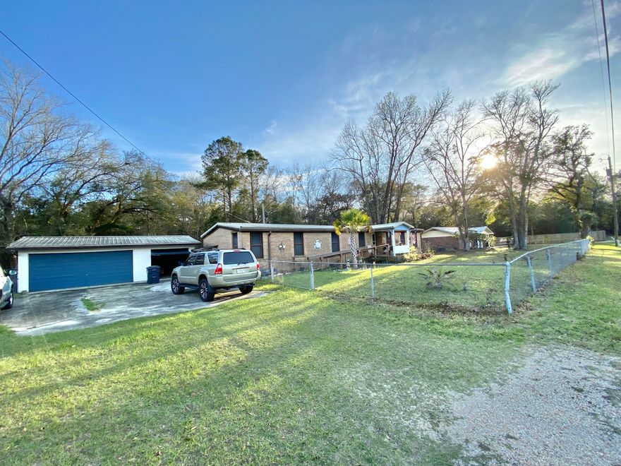 SPACIOUS 4 LOT PARCEL with a larger double wide mobile home located in a charming community just off of Bay loop Rd. Just minutes to downtown Freeport, Freeport Regional Sports Complex at Hammock Bay, Shipyard Boat Ramp (AKA Four Mile Point Public Boat Launch), and Freeport Marina and Yacht Club! This home offers ALL BRICK SIDING, 3 bedrooms/ 2 bath large floor plan, separate living and family room, formal dining room, a Florida room, and a completely fenced in yard providing ample privacy. RV, BOAT or both you have the space for your toys! 2 CAR DETACHED GARAGE made of concrete block with 2 shed or workshop areas. METAL ROOF 2020, all-inclusive AC/Heater combo just a year old and newer water heater. With its proximity to the Beach and ample parking could be a great short-term rental! Does need TLC like flooring, inside paint but with that can be fresh and new! You can really have the best of both worlds; quiet and seclusion yet just a short drive to all the action (beaches, shopping, dining, and entertainment) of the emerald coast. Buyer and buyers agent to verify all dimensions and anything deemed important.