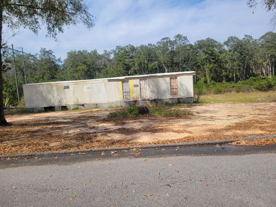 2 acres with a power pole and septic and water tap. Located on Paige street just east of DeFuniak Springs.  Mobile home is a total rebuild.... Fixer Upper . This is an ''AS IS'' sale.  Sell make no repairs property being sold and as his condition.