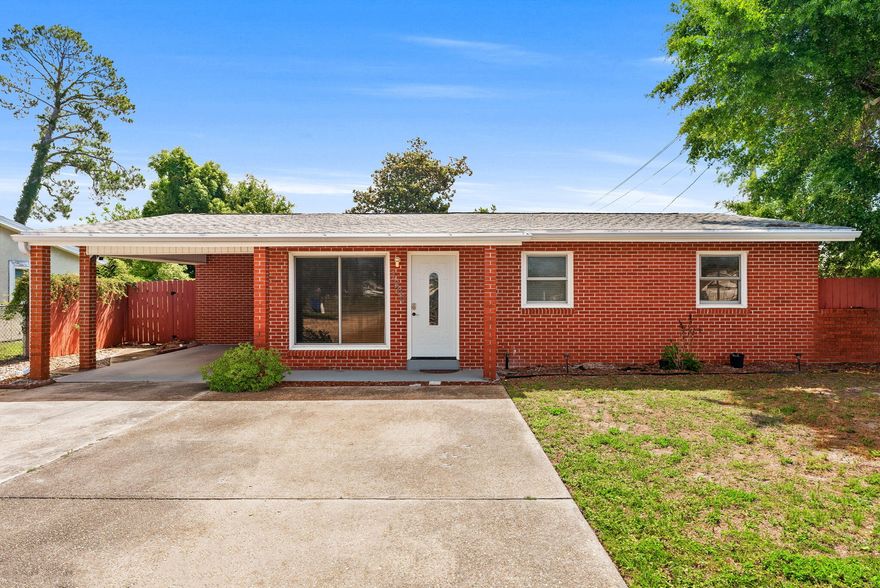 Welcome to 1900 Beck Ave., a beautifully maintained all-brick home perfectly positioned just minutes from the heart of Historic St. Andrews which is one of Panama City's most sought-after waterfront communities known for its vibrant coastal charm, local restaurants, marinas, boutique shopping, waterfront parks, farmers markets, and year-round community events. 

Situated on a spacious corner lot, this 3-bedroom, 2-bathroom residence combines comfort, functionality, and convenience. Step inside to discover a massive 23x25 living room highlighted by luxury vinyl plank waterproof flooring, creating the perfect space for entertaining or relaxing. The updated kitchen features stainless steel appliances, elegant white cabinetry, granite countertops, and a custom backsplash, blending style and practicality seamlessly.

Additional upgrades include all new PEX plumbing throughout, a reliable ADT security system, and the added benefit of being located in Flood Zone X, where flood insurance is not typically required. A new roof was installed in 2018, and the home currently carries an affordable homeowner's insurance premium available upon request. Outside, the oversized double driveway and covered carport provide ample parking for multiple vehicles, while the large, fenced backyard with convenient access gates offers ideal space for boat or RV storage, perfect for those wanting to take advantage of the nearby bay, marinas, and waterfront lifestyle. Enjoy outdoor gatherings on the spacious covered patio or unwind in the private backyard complete with a farmhouse-style storage shed. 

Living near Historic St. Andrews offers a unique coastal lifestyle where golf cart rides to dinner, sunset walks along the bay, live music, boating adventures, and weekends at the marina become part of everyday life. Whether you are enjoying fresh seafood at locally loved restaurants, exploring nearby coffee shops and boutiques, or taking advantage of the area's shopping, dining, entertainment, and commercial conveniences, this location places you near the very best of Panama City. With exceptional accessibility and strong appeal for both homeowners and investors alike, this property presents an incredible opportunity for first-time buyers, long-term rental potential, or anyone looking to embrace the relaxed coastal lifestyle that makes St. Andrews such a desirable place to live. Schedule your private showing today!