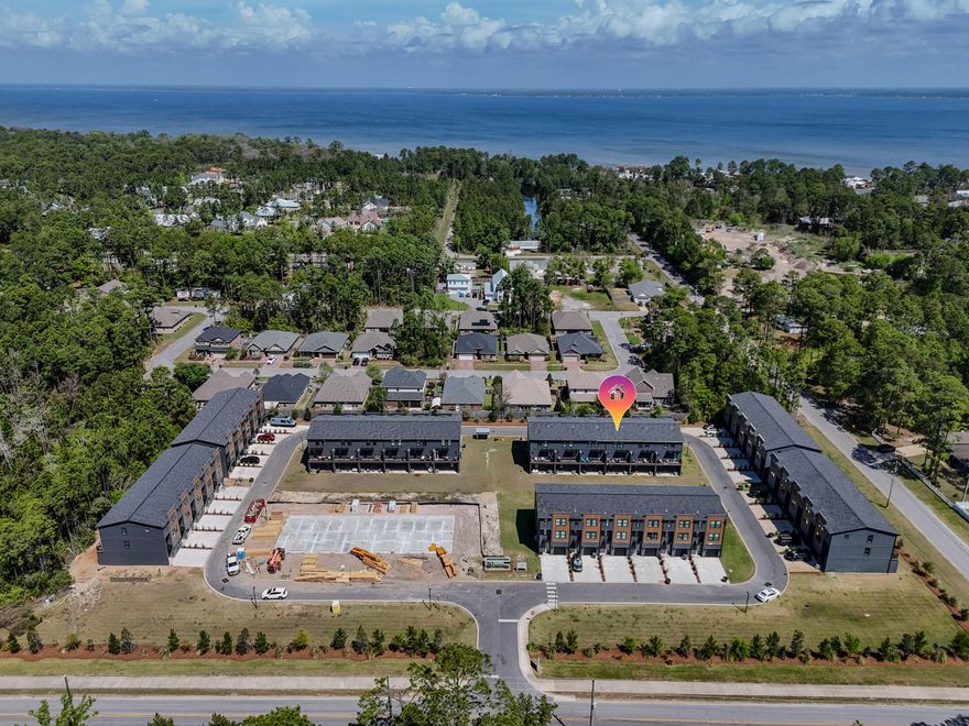 Welcome to 99 Blue Eden Loop, a meticulously maintained resale in the highly desirable 30 North community. This thoughtfully upgraded townhome offers a comfortable blend of modern features and easy coastal living, all just minutes from the Bay and local favorites like Farm & Fire and North Beach Social.

Inside, you'll find upgraded pendant lighting that adds warmth and character, along with practical features like a Culligan water softener and whole-house shutters for added comfort. The garage has been finished with an epoxy floor, and an EV charger is already in place, making this home truly move-in ready.

Whether you're looking for a primary home, second home, or investment property, this one stands out for its upgrades, location, and overall condition.