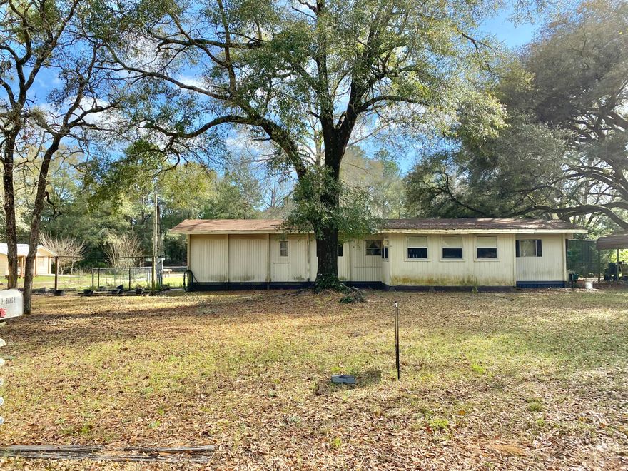 Beautiful lot with older Mobile home close to all Crestview has to offer. Fixer upper! Seller has left all contents inside and would be buyers' responsibility to remove. Home may need roof replaced. All other issues would have to be found out during inspection as sellers have no idea of conditions. It does have an AC unit, water heater, propane tank and power pole. There is a nice metal carport that can house 2 vehicles, 2 storage sheds in good shape and partially fenced in back and side yard. 
Buyer and buyers agent to verify all dimensions and anything deemed important.