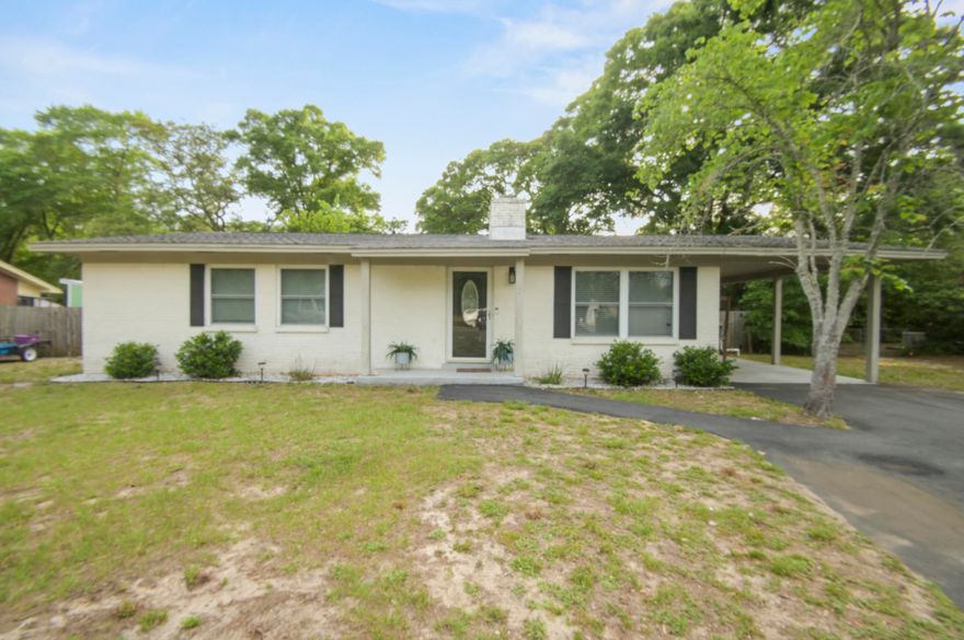 This beautifully updated brick 3-bedroom, 2-bath home in The heart of Fort Walton Beach checks all the boxes. The open floor plan makes the space feel larger than it is, with ceramic tile running through all main living areas and carpet in the bedrooms. The kitchen has been tastefully modernized with granite countertops, subway tile backsplash, and stainless steel appliances and modern units.  The sun-filled family room is the heart of the home, anchored by a wood-burning fireplace and opening directly to a large, fenced backyard with a generous patio and pergola -- ideal for weekend cookouts or winding down in the evenings. The master suite features a tiled master shower and updated vanity give the primary bath a clean, finished look.  Updates over the past few years include the AC unit, water heater, paint, lighting, and flooring, so the big-ticket items are already handled. The community also features a private boat launch -- a standout perk for anyone who enjoys life on the water. Located in Colony Estates, you're just minutes from schools, shopping, and restaurants, with easy access to Hurlburt Field, Eglin AFB, and the beaches of Okaloosa Island. This one is worth a look -- schedule your tour today!