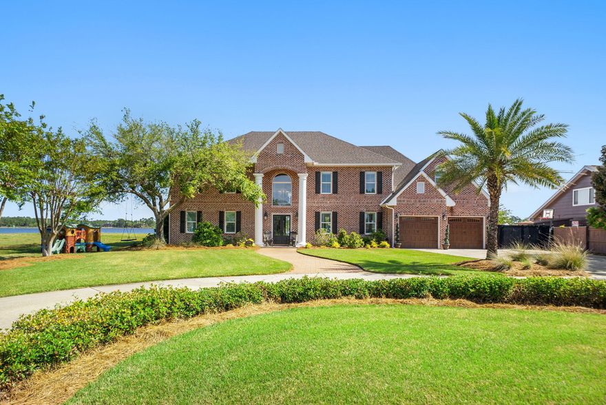 Coastal living at its finest! Discover your WATERFRONT slice of paradise in the heart of Lynn Haven, Florida, where everyday living feels like a permanent vacation. 

This stunning 2-story, 5-bedroom, 6-bathroom home with NO HOA features 5,575 square feet, a private pool and with pure Bay views, it offers the perfect blend of Florida charm and modern comfort, just minutes from pristine beaches and world-class fishing out your back door. Where privacy meets paradise, this bayfront estate is nestled on a quiet cul-de-sac with 130' water frontage on Upper Goose Bayou. 

This magnificent home sits on an expansive .79-acre homesite featuring your own private beach area and boat dock, with an additional dock currently in development. Wake up each morning in the luxurious main-level primary suite to breathtaking water views and the sea breezes from your covered back porch. You're going to love the oversized bedrooms, walk-in closets and high ceilings in this home! This estate also features a large bonus/flex room centered in the middle of the bedrooms upstairs as well as a very large flex bonus room which is great for an additional game room, storage for holiday items or even an additional bedroom, if needed. 

The upstairs is complete with a kitchenette and laundry for easy access and entertaining, as well. A home office is on the main level and just across from the primary suite giving easy access to pop in to work when needed in early hours or late evenings without interrupting the family. The family room flows on the main floor flows seamlessly from the foyer and provides extra-large picture windows and French doors with views to the Bay. The formal dining room sets the stage for holiday gatherings and separation when needed while providing additional seating for daily use. The kitchen is a showpiece blending a transitional feel with beautiful light cabinetry, a walk-in pantry, an island overlooking the pool and Bay and an abundance of cabinetry. 

Picture living in your own personal resort with this oversized estate homesite and dive into your private pool after a day of boating or fishing, or cast a line right from your backyard dock. The gorgeous brickwork adds timeless elegance to this coastal retreat, where every detail speaks to quality craftsmanship with a fireplace and multiple seating areas to gather. 

If you're looking for a family home for generations to come, this one checks all the boxes. Room for your family to grow, room for your family to host and room to truly LIVE the coastal waterfront lifestyle you've dreamed about! Just outside of Panama City, Lynn Haven's vibrant community offers small-town charm with big-city amenities, from waterfront dining to family festivals. 

With top-rated schools nearby and Panama City Beach's sugar-white sands just moments away, this isn't just a home, it's your gateway to the ultimate Florida lifestyle.