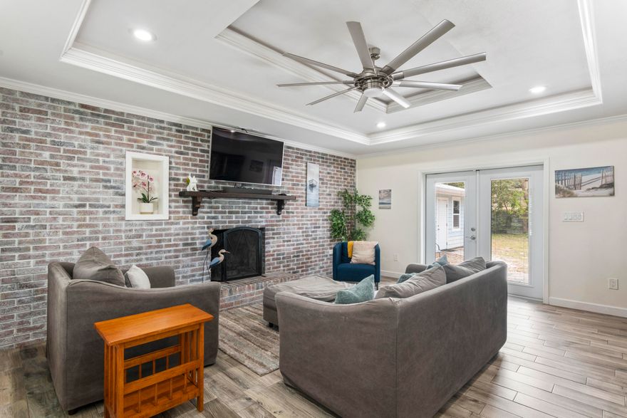 Welcome to 204 Coral Drive--beautifully renovated and truly move-in ready. This charming 3-bedroom, 2-bath home blends modern upgrades with a relaxed coastal feel. A standout feature is the fully paid solar panel system, installed in 2021 and valued at approximately $60,000, included at no cost to the new owner--keeping energy expenses extremely low with only about a $30/month connection fee.

Step inside to a spacious living room featuring elegant tray ceilings, a stunning brick accent wall, and a cozy fireplace, all complemented by durable tile flooring that runs throughout the home. The fully updated kitchen is designed to impress with stainless steel appliances, granite countertops, and custom soft-close cabinetry--perfect for both everyday living and entertaining. The thoughtfully designed laundry room includes a utility sink and ample workspace, adding both convenience and functionality. The primary suite offers a private retreat with dual vanities and a beautifully tiled walk-in shower. Nearly every detail has been upgraded, including faucets, fixtures, and ceiling fans, giving the home a fresh, modern feel throughout.

Situated on a generous 90' x 130' lot, the property features a large fenced backyard with plenty of room to enjoy. You'll love the separate workshop--ideal for hobbies or storage--as well as the covered patio with stunning wood ceilings, perfect for relaxing or hosting guests. Mature trees provide shade and enhance the home's inviting coastal ambiance.

Additional features include a one-car garage and countless upgrades throughout. Conveniently located and packed with value, this home is a must-see.