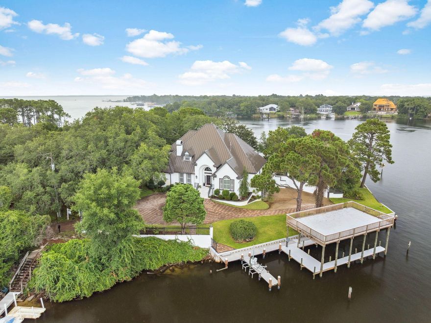 Exquisite Waterfront Oasis on Joe's Bayou *No HOA***

Experience the pinnacle of waterfront living with this stunning estate situated on a rare .87-acre peninsula point lot, offering an extraordinary 657 feet of prime water frontage along the serene waters of Joe's Bayou. Recently completed renovations enhance both style and functionality, creating a move in ready coastal retreat designed to capture the beauty of its remarkable surroundings. With deep water access and a newly constructed waterfront deck, the property is perfectly positioned for boating enthusiasts and those seeking to fully embrace the bayou and Gulf lifestyle. Home Features

                         Expansive Living Spaces
Nestled within this majestic waterfront setting is a beautifully renovated residence featuring four generously sized bedrooms and three full bathrooms. Thoughtfully designed for both comfort and sophistication, the home offers an ideal layout for everyday living as well as effortless entertaining.

                      Panoramic Water Views
Experience tranquil bayou living with sweeping water views showcased throughout the home. Expansive windows invite abundant natural light while framing breathtaking views from nearly every room, a truly distinctive feature that sets this property apart.

                           Unlimited Potential
An unfinished third story presents an exceptional opportunity to expand and customize. Whether envisioned as an additional bedroom suite, entertainment lounge, home office, or creative retreat, this flexible space allows you to tailor the home to your lifestyle.

                     Outdoor Waterfront Paradise
The estate's expansive grounds are equally impressive, surrounded by lush, mature landscaping that provides remarkable privacy and serenity. Enjoy stunning 270-degree panoramic water views, creating a peaceful sanctuary where nature and luxury coexist seamlessly.

Additional Luxuries

                   Extensive Parking & Three-Car Garage
The property offers ample parking for 10+ vehicles, complemented by a spacious three-car garage -- ideal for hosting guests, storing recreational equipment, or accommodating a multi-vehicle household.

                              Private Gated Entry
A secure entrance gate welcomes you into this secluded retreat, tucked among dense greenery and natural beauty, offering both privacy and peace of mind.

                            Ideal Location
Situated on the highly desirable waters of Joe's Bayou, this exceptional property provides direct access to boating, paddleboarding, fishing, and other waterfront activities right from your backyard.

Notably, the home is not subject to HOA restrictions, allowing owners the freedom to personalize and enjoy their property without additional limitations.

Whether you are a boating enthusiast seeking effortless water access or someone longing for a serene luxury retreat surrounded by nature, this remarkable waterfront estate delivers a lifestyle where every day feels like a vacation.

Don't miss this rare opportunity to own a truly unique bayou-front sanctuary.