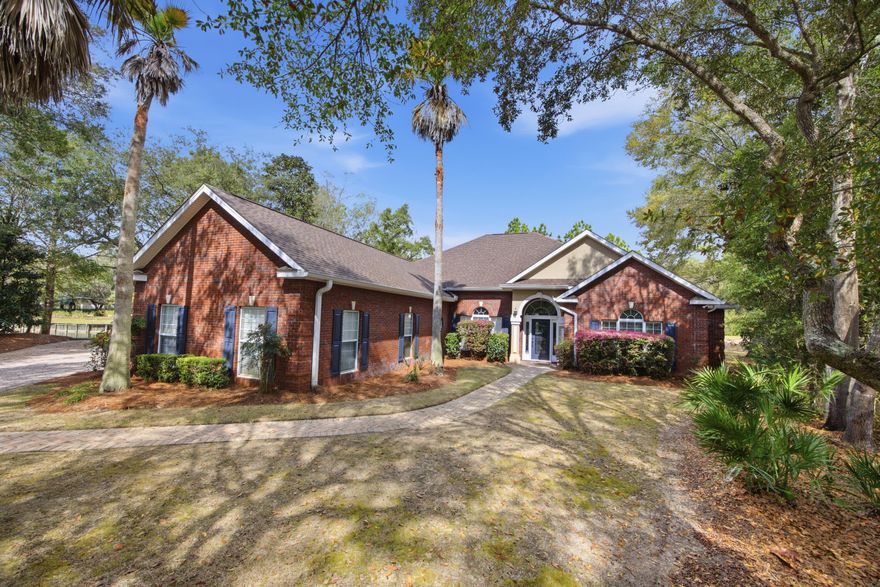 Beautiful CUSTOM built brick home, situated lakefront on a quiet cul-de-sac in GATED Magnolia Plantation!  Spacious, open floor plan offers four bedrooms, three full and one half bath, formal dining (currently office) enclosed sunroom, side entry 2-car garage, screened LINAI with POOL.  Features includes hardwood floors, raised and trayed ceilings, granite counters, walk-in pantry, generously sized master suite with two walk-in closets, jetted tub, walk-in showers, dual vanities, private water closet.  Front guest bedroom with ensuite bath could also be a study/office.  Two additional bedrooms with shared bath.  Great location close to bases, schools, shopping.  Just a short drive to the bridge, beaches, attractions, shopping and restaurants in Destin. All dimensions should be verified.