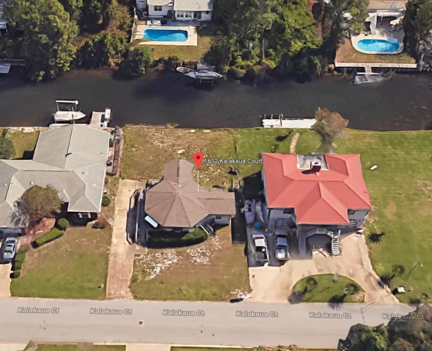 Waterfront Home! This 2 bedroom 1 bath is the perfect investment opportunity. The lot backs up to a private canal in the Polynesian Islands neighborhood. Great front and backyard space, being sold as is.