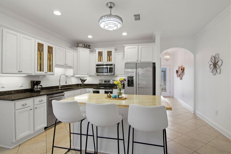 A 'jewel' in Hammock Bay, ready to move in to and enjoy. Meticulously maintained and upgraded with attractive features to enhance your living experience. Lovely kitchen with added drawers, enlarged island, single basin sink, and a full use butcher block countertop. Two convenient pantry closets for food and supplies. Newer kitchen appliances, tiled backsplash, recently painted interior and tiled floor simplify maintenance; allowing for more time to enjoy the large fenced backyard, 500+ sq ft patio, and outdoor living. Established landscaping, full lawn sprinklers, inviting spaces, and room for backyard games/BBQ/activities. Adjoining greenbelt privacy.  Other highlights include: ceiling fans (6), 8' x 15' outdoor storage shed (w/ electricity), gas hot water heater, induction stove top, programable thermostat, solar powered attic fan, newly painted interior and exterior, Ninja Epoxy flooring, plumbed garage sink, added cabinet storage, gutters/downspouts for optimal drainage, and insulated garage door. Dedicated rf/freezer outlet, attic storage, hot water recirculation, ring door bell, and wired for ADT security.    This home is ready to meet the needs of your best Florida lifestyle!