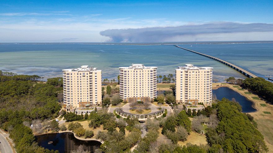 Positioned on the highly desirable fourth floor of One Water Place at Kelly Plantation, this impeccably renovated residence represents one of the Emerald Coast's most refined opportunities for luxury ownership. Overlooking the tranquil waters of Choctawhatchee Bay and the pristine fairways of the Fred Couples Signature Golf Course, this sophisticated two-bedroom, two-and-a-half-bath home delivers the elevated lifestyle discerning buyers expect in one of Northwest Florida's most prestigious gated, non-rental communities.

Accessed through a private elevator vestibule, the residence immediately sets a tone of exclusivity and intention. The open-concept interior is filled with natural light and thoughtfully designed to balance elegance with everyday comfort. White oak hardwood flooring, professionally detailed neutral finishes, custom glass entry doors, and refined architectural elements create a seamless, timeless aesthetic throughout.

The gourmet kitchen has been masterfully designed for both beauty and performance, featuring custom solid walnut cabinetry extending through the kitchen, baths, and laundry. Premium pull-outs and drawer dividers, a custom walnut pantry wall, and striking stone countertops deliver exceptional function, while hidden outlet strips, under-cabinet LED lighting, and a dramatic recycled glass tile backsplash provide modern sophistication and visual impact. Every fixture and finish has been carefully selected to reflect continuity, quality, and enduring style.

The primary suite serves as a private sanctuary, offering spa-level comfort with a custom marble backsplash, extended tilework to the ceiling, upgraded Toto fixtures, and a heated towel warmer. Polished and honed travertine flooring, designer wall coverings, custom closet systems, motion-activated LED lighting, and ceiling fans in every room demonstrate the level of detail and thoughtful planning rarely found in condominium living.

The expansive balcony is designed to fully embrace the Emerald Coast lifestyle, functioning as an extension of the home's living and entertaining space. A fully appointed outdoor kitchen features a deluxe gas grill, beverage refrigerator, weatherproof custom cabinetry, and stone countertops with integrated sink -- all positioned to capture sweeping bay breezes and panoramic golf course views that change beautifully throughout the day.

Extensive system and mechanical upgrades provide peace of mind and long-term comfort, including Carrier HVAC systems, updated hot water heater, gas fireplace blower, washer and dryer, upgraded hardware throughout, and professionally finished paint across all surfaces.

One Water Place at Kelly Plantation offers a private, resort-caliber lifestyle reserved exclusively for residents. Amenities rival those of an elite private club and include a bi-level heated lap pool, spa treatment rooms, an expansive fitness center, wine tasting room with private lockers, bocce courts, putting greens, scenic walking trails, a dog park, and access to an equestrian center. Two underground parking spaces and a private storage room provide rare convenience and security.

As a top luxury real estate professional representing premier properties across the Southeast United States, I can confidently say this residence stands among the finest condominium offerings along Florida's Emerald Coast. Perfectly located near Destin's world-renowned beaches, boating, championship golf, and exceptional dining, this move-in-ready home offers a rare combination of design excellence, privacy, and lifestyle distinction.

For the buyer who expects the very best, this is more than a residence -- it is a statement of refined coastal living in one of the Southeast's most coveted luxury communities.