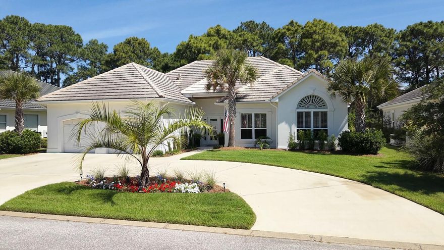 This impeccably designed 2227 sq. ft. single-story home offers 3 bedrooms, 2 bathrooms, and a dedicated office, blending coastal charm with elevated sophistication at every turn. Wide-plank hardwood floors flow seamlessly throughout, anchoring each sun-filled room in warmth and style. The grand living room captivates with soaring vaulted ceilings, a stunning fireplace flanked by custom built-ins, and French doors that spill natural light across the space. The open kitchen-living area is a chef's dream -- featuring a sweeping quartz waterfall island, taupe shaker cabinetry, subway tile backsplash, and stainless appliances beneath elegant arched architectural details. The primary suite is a true sanctuary, boasting a coffered ceiling, plantation shutters, and rich hardwood floors. Its spa-inspired ensuite stuns with dramatic marble-look tile, an arched window, soaking tub, and double vanity. Guest spaces are equally refined, with light-filled rooms and a beautifully appointed second bath with gold-accented fixtures. An in-home office adds versatile functionality. This is more than a home -- it's the Destin dream, perfectly lived.