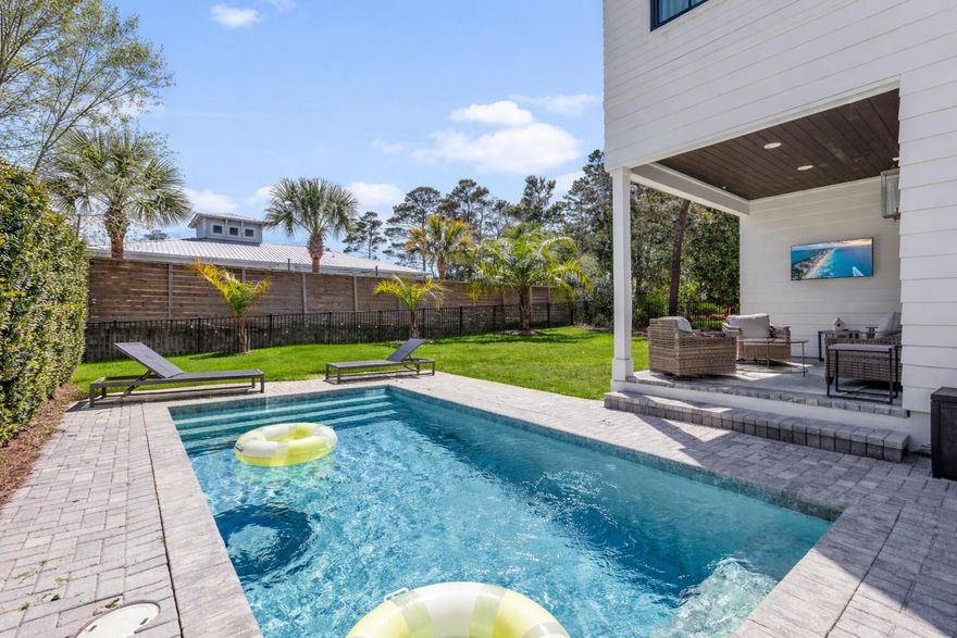 Tucked away on a quiet dead-end street off 30A, this custom coastal retreat offers privacy, comfort, and a prime Santa Rosa Beach location. Built in 2020, this 4 bed, 4 bath home features an open concept living space with engineered hardwood floors, shiplap accents, gas fireplace, and a chef's kitchen with quartz countertops, custom cabinetry, island, and Thermador range. Step outside to a private backyard with a 20 ft pool, brick paver patio, and fenced yard, perfect for relaxing or entertaining. Designed for full time living or rental potential, the layout includes a main level bunk room and three upstairs en suite bedrooms, including a spacious primary suite. Located in Gulfview Heights with no HOA, just a short walk or bike ride to beach access, dining and shopping.