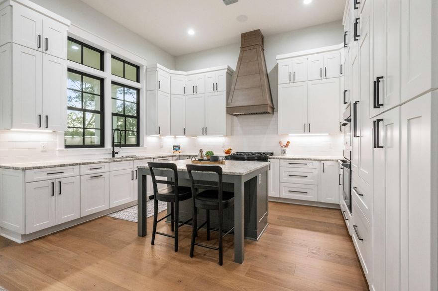 The only three-story home in Deer Moss Creek with a private in-law residence and separate entrance, 153 Caraway Drive offers a rare opportunity for luxury multi-generational living in one of Niceville's most sought-after communities.
Built in 2024, this exceptional 3,822-square-foot, 4-bedroom, 3.5-bath luxury estate was thoughtfully designed to provide both connection and privacy across three levels of beautifully appointed living space.
From the moment you arrive, the oversized parking area and architectural presence set the tone for what lies within. Step inside and you are welcomed by 12-foot ceilings, engineered hardwood floors, and a stunning gas fireplace that anchors the open main living space. Thoughtfully designed for both everyday living and entertaining, the chef's kitchen showcases granite countertops, custom cabinetry, tile backsplash, a large gathering island, integrated Thermador refrigerator, and Z-Line gas cooktop.

The main-level primary suite offers a spa-inspired retreat, complete with quartz countertops, double vanities, a massive tiled walk-in shower, custom closet, and elegant nickel gap wall paneling that adds warmth and architectural character. Remote-controlled blinds are installed in the bedrooms, providing both convenience and comfort.

Step outside to the Trex deck off the dining area, where peaceful views of the natural preserve and nature trails create the perfect setting for morning coffee or evening gatherings.

The lower level was designed for both relaxation and entertaining, featuring a spacious secondary living area and a dedicated movie theater room with theater seating that conveys with the home. The theater space features its own Sonos sound system, delivering an immersive cinematic experience. Two additional bedrooms and a full bath provide comfortable accommodations, while French doors lead to the covered patio and backyard that backs to Deer Moss Creek's scenic nature trails and preserved green space. The yard offers plenty of room to design a future pool and outdoor retreat. This level also includes a gym area, extensive storage, and a poured concrete safe room.

The top floor offers a completely private executive-level in-law suite, including its own entrance, full kitchen with granite countertops, spacious living area, bedroom, bonus room, laundry, and a covered Trex balcony overlooking the nature trails and preserved natural area. This level creates unmatched flexibility for extended living arrangements or long-term guests.

Designed with comfort and privacy in mind, the home includes spray foam soundproofing between each floor and a whole-house Sonos sound system, allowing music to flow throughout the home while the theater room maintains its own dedicated audio experience.

Additional premium features include:
" Whole-house Sonos music system
" Dedicated theater room sound system with theater seating included
" Three independent HVAC systems
" Commercial Generac whole-house generator
" Granite countertops in kitchens and baths
" Quartz countertops in the primary suite
" Engineered hardwood flooring and tile baths
" Remote-controlled blinds in the bedrooms
" Extra interior garage storage
" Oversized parking area

Deer Moss Creek is known for its vibrant lifestyle and strong sense of community. Residents enjoy a neighborhood pool, clubhouse, more than five miles of paved nature trails, extra-wide sidewalks, and community events including food trucks, seasonal celebrations, and social gatherings throughout the year. The area is also known for its highly rated schools, making it a sought-after location for those who value education, community, and lifestyle. Niceville and Deer Moss Creek provide a wide range of amenities and experiences designed to suit every stage of life.

Located just minutes from Eglin Air Force Base, shopping, dining, and the Emerald Coast's beautiful beaches, this home offers the perfect balance of luxury, lifestyle, and convenience.

This is more than a home--it is a thoughtfully designed property that offers elevated living, privacy, and flexibility in one of Niceville's most desirable communities.