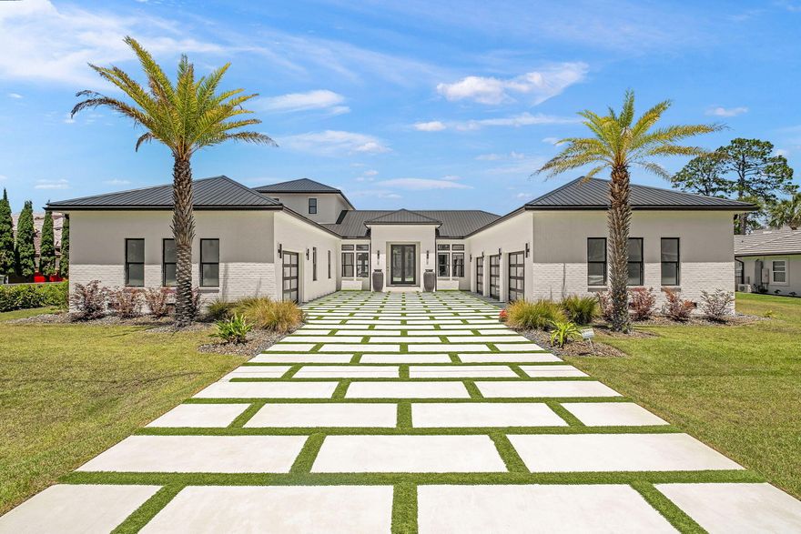 Perfectly positioned on the bay and masterfully constructed, this extraordinary coastal modern estate is a showcase of intentional design, elevated craftsmanship, and effortless luxury living. From the moment you arrive, the striking custom modern driveway, dramatic architecture, and symmetrical approach framed by towering palms create an unforgettable first impression. Inside, walls of glass capture breathtaking panoramic bay views while warm Cypress wood accents soften the home's clean contemporary lines, creating a elevated yet inviting atmosphere throughout.

Designed with both grand scale entertaining and everyday comfort in mind, the residence features expansive open living spaces, upgraded lacquer cabinetry, oversized closets throughout, and a thoughtfully designed walk in pantry with exceptional storage. The chef's kitchen flows seamlessly into the main living and dining areas, all perfectly positioned to maximize the sweeping waterfront backdrop. A stunning upstairs recreation room offers an additional entertaining space complete with wet bar, beverage refrigerator, ice maker, and incredible views from the second level.

The luxurious primary suite is a true retreat, featuring spa inspired finishes including a steam shower with dual rain heads and handheld fixtures, a TOTO heated toilet, and beautifully curated designer details. Every guest bedroom offers the privacy and convenience of its own en suite bath. 

Additional specialty spaces include a custom wine cellar, built-in pet wash station, separate upstairs storage room with garage access, and heated/cooled garages with beautifully crafted custom garage doors.

This smart home is extensively equipped with premium technology and infrastructure including Control4 whole-home automation, integrated security system, Lutron lighting, Sonos audio, underwater speaker system wiring, exterior Jellyfish lighting, invisible fence system, whole-house generator, and a whole-home water filtration system. Even the sprinkler system is equipped with filtration to help prevent exterior staining.

The outdoor living is equally spectacular. The fully turfed backyard was designed for low-maintenance luxury and features a private putting green, a stunning negative-edge saltwater pool and spa, expansive covered entertaining areas, outdoor kitchen with beverage center, SunBrite outdoor TV, outdoor shower, and dedicated pool bath. The sweeping bay views create an incredible backdrop for waterfront living, offering the perfect setting for both peaceful mornings and unforgettable evenings. Extending from the property is a private dock complete with both boat lift and two jet ski lifts, offering immediate access to life on the water.

Blending refined coastal elegance with state of the art amenities, this one of a kind waterfront residence delivers an extraordinary lifestyle experience from every angle.