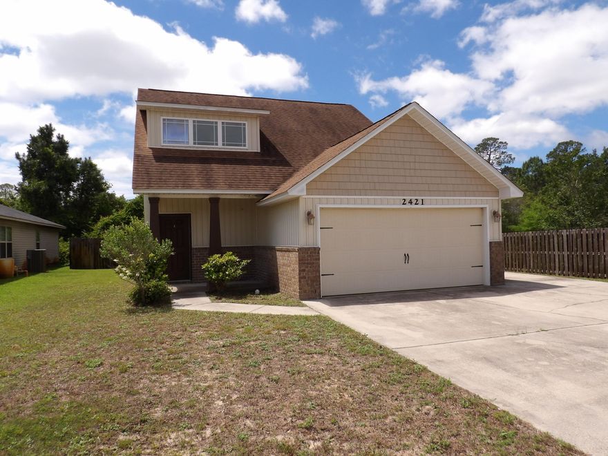This Craftsman-style home blends architectural charm with modern convenience -- perfect for families, professionals, or anyone seeking a comfortable Florida lifestyle. The thoughtful layout maximizes light and flow, while its location in Navarre ensures beach access, shopping, and amenities are nearby, making errands easier and weekends more enjoyable! Close to schools and plenty of room for outside activities and pets.  This 4-bedroom 2.5 bath home features an open floor plan on the first floor with a large living room and large kitchen with granite counters. brand new paint, carpet, and a new AC. The primary bedroom is also on the first floor, and the M bath features double vanities and a garden tub along with walk in closet. There is also 1/2 bath and a laundry room on the first floor As you head up the stairs you come to a landing that could be a sitting area or play area.  The 3 upstairs bedrooms are good sized and feature cathedral ceilings and there is a full bath. Home also has a 2-car garage and a privacy fenced backyard.