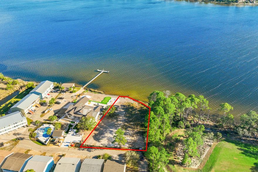 Build your dream home on this exceptional .74-acre waterfront homesite on Lake Powell--Florida's largest coastal dune lake. Rarely do opportunities like this come available, offering both generous depth and expansive frontage along the main body of the lake. With no restrictions on vacation rentals, this property presents incredible flexibility--whether you envision a private coastal retreat or a high-performing investment property. The size and setting allow for the creation of a true destination-style residence, with ample room for outdoor living, a private pool, private dock and boat lift, providing seamless access to Lake Powell and the Gulf and beaches. Ideally positioned in West Panama City Beach, you're less than a mile to the nearest beach access and just moments from from the dining, shopping, and charm of Scenic Highway 30A, as well as the natural beauty of Camp Helen State Park. Just beyond the inlet, the Gulf waters offer access to nearby artificial reefs and productive fishing grounds--adding to the exceptional waterfront lifestyle this location provides. An exceptional opportunity to build, invest, and enjoy one of the area's most sought-after waterfront settings.