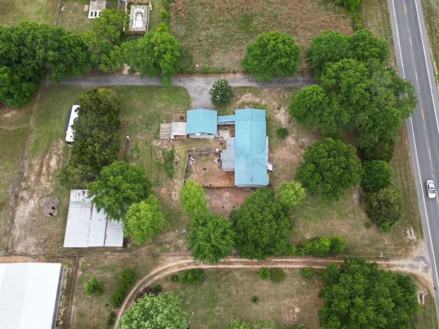 Set on 1.34 private acres, this thoughtfully equipped property is designed for those who value space, function, and the outdoors--offering a fully equipped country lifestyle with room to live, work, and pursue your passions.

This move-in ready 3-bedroom, 2-bath home features an open floor plan and a fully renovated kitchen with abundant counter space, soft-close cabinetry, granite island, updated appliances, and modern finishes--perfect for both everyday living and entertaining. Ceiling fans throughout the home and on the porch add comfort year-round, while a handicap-accessible ramp with durable Trex-style decking provides added convenience and ease of entry. The spacious primary suite includes vaulted ceilings, a large walk-in closet, and an en suite bath with soaking tub, separate shower, and linen storage.

Enjoy the expansive sunroom overlooking a fenced backyard retreat--ideal for relaxing, pets, or gardening. A separate outdoor patio area offers additional space for entertaining and enjoying the peaceful surroundings.

The property is thoughtfully equipped for those who enjoy hobby farming, entertaining, or working from home. A standout feature is the impressive 1,692 SF barn (2015), including 864 SF of air-conditioned workspace with running water, 220 amp service, loft storage, and four covered exterior bays with power and lighting--ideal for equipment, projects, or additional parking.

Additional highlights include:

Two RV hookups with septic access
Greenhouse, she shed, raised garden beds, and worm beds
Established fruit trees and plants including grapes, blackberries, blueberries, peach, tangerine, guava, and more
Water and electric access throughout the property
Fish cleaning station with integrated worm bed
Outdoor prep areas including a hunter's game lift
Durable metal roof (approx. 5 years old) and 2024 water heater
Security system
Shared main driveway access, plus a separate private driveway with ample parking and covered carport

With a rare combination of privacy, functionality, and outdoor lifestyle amenities, this property offers something for everyone--from peaceful country living to space for hobbies, work, and recreation.

Schedule your private showing today to experience all this unique property has to offer.
