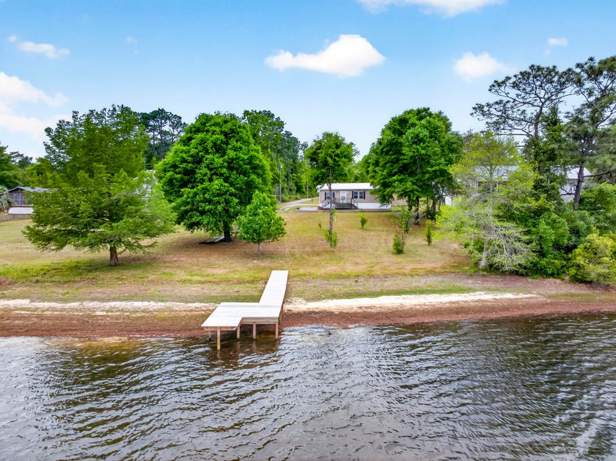 Charming 2-bedroom, 2-bath lakefront home situated on a full acre! This property features a detached garage/shop, additional carport, and a beautiful dock--perfect for enjoying stunning sunset views over the water. Don't miss out--call today to schedule your private showing!