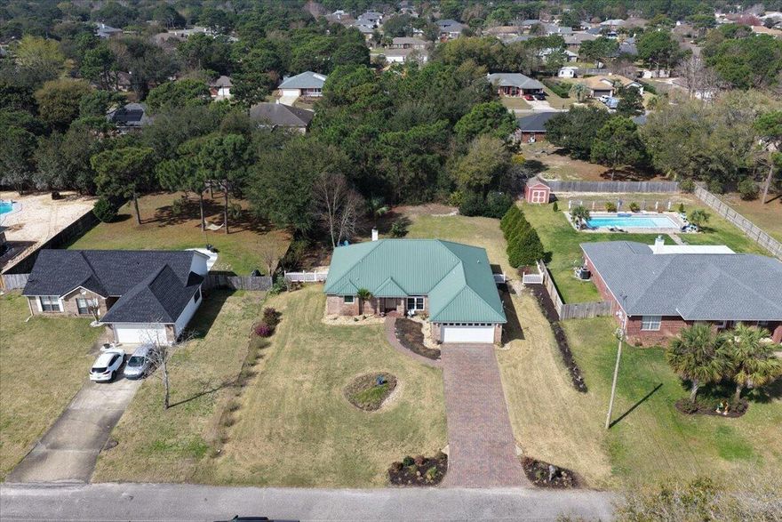 Welcome to 1933 Seahawk in Navarre, where thoughtful updates and beautifully designed outdoor spaces make this home truly stand out. From the moment you arrive, the custom paver driveway and walkway, professionally designed landscaping, and Zoysia sod installed in the front yard in 2021 create inviting curb appeal and a polished first impression.

Inside, you'll find fresh, modern updates throughout. New luxury vinyl plank flooring installed in 2025 adds style and durability, while the kitchen and great room refresh completed in 2025 create a bright, updated living space perfect for both everyday living and entertaining. The kitchen features stainless steel appliances and flows seamlessly into the main living area. Welcome to 1933 Seahawk in Navarre, where thoughtful updates and beautifully designed outdoor spaces make this home truly stand out. From the moment you arrive, the custom paver driveway and walkway, professionally designed landscaping, and Zoysia sod installed in the front yard in 2021 create inviting curb appeal and a polished first impression.

Inside, you'll find fresh, modern updates throughout. New luxury vinyl plank flooring installed in 2025 adds style and durability, while the kitchen and great room refresh completed in 2025 create a bright, updated living space perfect for both everyday living and entertaining. The kitchen features stainless steel appliances, beautiful coastal look cabinets and granite countertops. The kitchen flows seamlessly into the expansive main living area featuring a beautiful fireplace. 

The primary suite was also transformed in 2025, offering a beautifully refreshed retreat. The primary en-suite features a gorgeous garden tub and a curb-less shower with a large rain shower head.

Step outside to enjoy your own private backyard oasis. Designed for relaxation and outdoor living, the backyard features a beautiful custom water garden, a new oversized patio area, and an automatic awning installed in 2025 to expand your outdoor living space and provide shade and comfort. The LeafGuard® gutter system, also installed in 2025, adds even more convenience to this well-maintained property.

This home also includes important long-term improvements that add value and peace of mind, including a metal roof and hurricane impact windows installed in 2016 (with lifetime warranty). A 7x7 Craftsman shed added in 2024 provides additional storage and functionality.

With quality upgrades, attractive finishes, and exceptional indoor-outdoor appeal, this move-in ready home offers a wonderful blend of quality updates, function, and charm. Come tour today - this one won't last long!