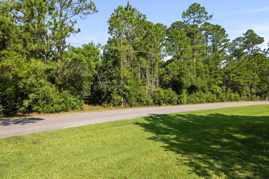 Create your ideal coastal retreat in the highly desirable Bay Pine Shores community of Santa Rosa Beach. This oversized homesite, spanning nearly half an acre, offers a rare combination of space, flexibility, and location. With low HOA fees and no required build-out timeline, you have the freedom to design and build on your schedule.

Conveniently located just minutes from 30A, Highway 331, and the white-sand beaches of South Walton, the property provides easy access to some of the area's best dining, shopping, entertainment, and outdoor recreation while still maintaining a peaceful neighborhood feel.

The surrounding area continues to see exciting growth and investment, including a newly approved 10,000-seat amphitheater planned just a few miles away, as well as a future scenic development featuring lakes and walking trails enhancing both lifestyle appeal and long-term value.

Significant due diligence has already been completed, including wetland mitigation finalized in November 2022. A wetlands survey and topographical survey are also available to the new owner, helping simplify the building process.

With very few homesites of this size remaining in Bay Pine Shores, this is a rare opportunity to secure a spacious property in one of South Walton's fastest-growing areas. Whether you're planning a primary residence or second home this lot offers exceptional potential in a prime coastal location.