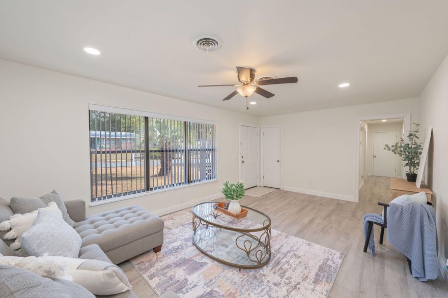 1/2 acre lot shaded by gorgeous mature oak trees, and backing up to military land for privacy, this updated single-family 3/2 home gives space! Perfectly positioned near military bases and sought-after A+ schools, making everyday life beautiful. Versatile spaces such as indoor laundry, bonus enclosed garage (Can easily be converted back to garage!), sun-room and attached workshop are not included in square footage, making this home big on space! Home has been refreshed with neutral flooring, no carpet! Scraped ceilings, no popcorn! Fresh paint, granite counters, and updated baths. Out back, the exterior deck invites gatherings under the trees, while the yard building provides room for projects and storage Gas hookups in the home for versatility. metal roof, newer water heater, newer appliances, full Electrical re-wire, lawn pump and NO HOA, bring your boat or RV and make it your own. Seller will add garage door back prior to closing with acceptable offer.