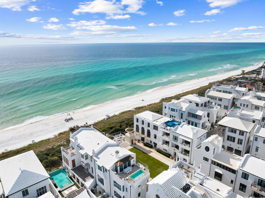 Nestled on Turtle Bale Walkway, and positioned in Alys Beach's most exclusive enclave of true gulf view homes, this extraordinary custom home, masterfully designed by Khoury Vogt, redefines coastal luxury. Commanding stunning Gulf views from 3 floors over Turtle Bale Green, this architectural masterpiece blends Old World artistry with contemporary sophistication. Vibrant accents in teal, seafoam and emerald greens, pale pink, and light blue complement Venetian plaster walls and exquisite fully custom wood finishes, create an exclusive, elevated living experience.

The first floor welcomes you through a striking iron pivot door into an octagonal entry rotunda, wrapped in custom wood paneling and floored with large Paris Casa Grey Limestone. A breathtaking suspended wood staircase frames views of the coveted ground level private pool and loggia. Additionally, this level features a fountain facing bedroom with a view of the iconic walkover. A charming bunk room, a full bath, half bath, elevator and an air-conditioned two-car garage with carriage-style doors and Christiana built-in cabinets, designed with room to install two lifts, for a total of four cars. Ascending to the second floor, the heart of the home unfolds with an open-concept living area framed by a seafoam green wood floating ceiling, and adorned with luxurious Minotti furniture. The Main area flows effortlessly from the state-of-the-art Bulthaup European kitchen, equipped with premium Gaggenau appliances, to the large balcony overlooking the gulf.  The formal dining room, enveloped in a strikingly elegant blue Venetian plaster, is separated from the main space by a custom glass partition, while a cozy inglenook conversation area invites intimate gatherings while staying connected to the main areas. A guest master suite and powder bath complete this level.

The third floor houses the opulent primary suite, a serene retreat with an oversized private balcony showcasing sweeping Gulf views. Its boutique-style Eggersmann closet system, featuring built-in jewelry cases and a private washer-dryer, redefines luxury. Marble-clad bathrooms, illuminated by exquisite old world chandeliers, elevate the experience, while a second guest master suite ensures ample space for family or guests.

Crowning the home, the fourth-floor rooftop deck is an entertainer's dream. Features include a full summer kitchen, conversation fire pit, Minotti outdoor furniture, bonus dog park, and a panoramic Gulf viewing area for morning coffee. Savor sunsets and host unforgettable family gatherings.

Premium Lowen fold away doors offer seamless flow from indoor to outdoor spaces, while vibrant tile accents and a curated blend of Old World art, bespoke lighting, and fine art pieces harmonize with modern baths and kitchen decor to create a vibrant and fun beach living experience. Convenience is prioritized with a Control4 smart house system, allowing customizable light, music and drapery scenes throughout. A full-house Culligan water purifier and water leak protection system with auto shut-off ensure peace of mind when away. Experience the harmonious, sophisticated beach lifestyle of 31 Sea Castle. With your ownership comes access to dramatic community pools, fitness spa, restaurants, private beach club, and tennis-pickleball center. 30-A is fast becoming a world class golf destination to compliment its award-winning beaches. This extraordinary proximity to beach access lies just a few steps from your beach retreat!