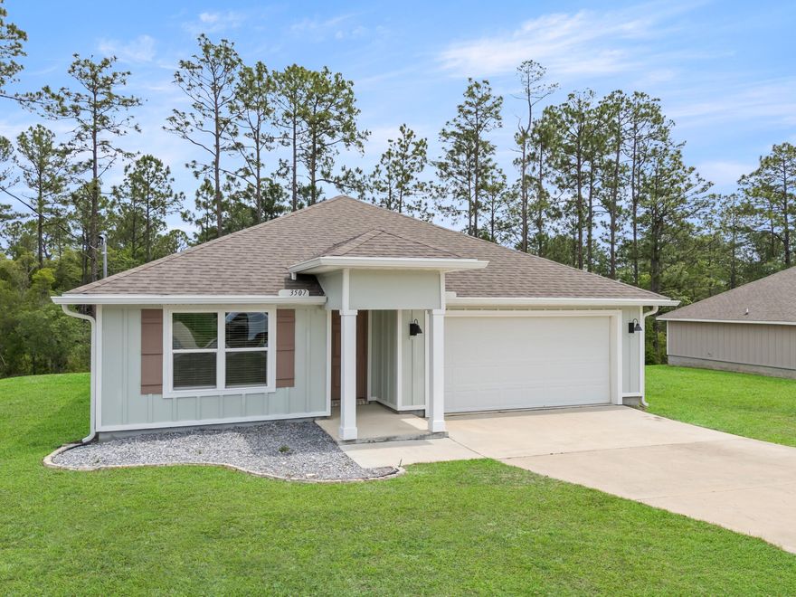 Tucked away in the quiet community of Timberland Ridge in North Crestview, 3507 Malus Court feels like the kind of home where life instantly slows down the moment you pull into the driveway. Built in 2022 and sitting on over a third of an acre, this property offers something that's becoming harder and harder to find -- space, privacy, and a backyard that stretches into the woods behind the home, creating a peaceful natural setting right outside your door.

As you step inside, the home immediately opens up with a bright and airy floor plan designed for both everyday living and entertaining. The engineered vinyl plank flooring flows throughout the main living areas, while the kitchen naturally becomes the heart of the home with its oversized island, stainless steel appliances, updated cabinet finishes, installed drawer pulls, and open sightlines into the living and dining spaces. Whether it's hosting family for the holidays, helping with homework at the counter, or enjoying a quiet morning coffee before the day begins, this home was designed for the moments that matter most.

Natural light pours through the windows, while blinds throughout the home and ceiling fans in every room add comfort and practicality already in place for the next owner.

The split bedroom design offers an ideal balance of privacy and functionality. Three guest bedrooms are positioned toward the front of the home, creating the perfect setup for family, guests, a home office, or hobby spaces. Tucked away near the back of the home, the primary suite becomes its own private retreat with a spacious ensuite featuring double vanities, a standalone shower, and not one, but two closets.

Step outside onto the covered back porch and you'll quickly understand what makes this property special. With the lot extending into the wooded backdrop behind the home, there's a sense of peace and separation that's hard to put into words. It's the perfect spot for slow mornings, weekend grilling, evening conversations, or simply enjoying the quiet surroundings after a long day.

Located in one of North Crestview's growing communities and priced at $303,000, this move-in ready Craftsman-style home blends modern convenience, thoughtful design, and the kind of setting that truly feels like home.