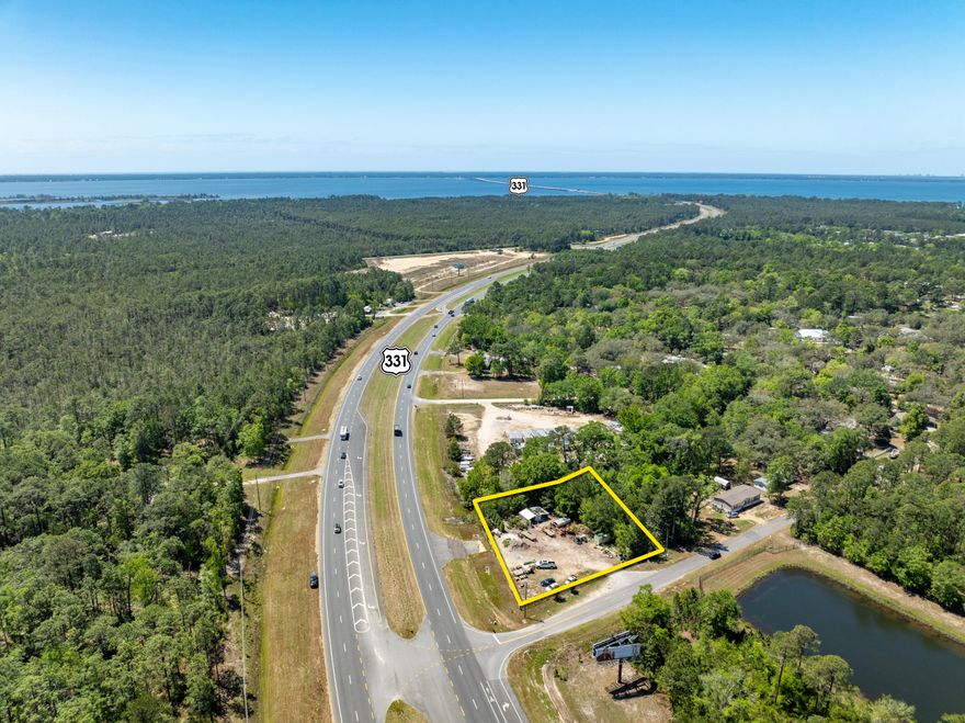 Exceptional corner parcel assemblage offering high visibility, deceleration lane, and median crosscut across Highway 331 in the emerging market of Freeport, Florida!