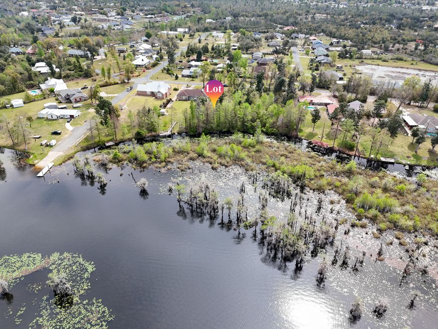 Build your dream retreat on this exceptional 0.58-acre canal-front homesite offering 100 feet of water frontage with direct access to Deer Point Lake. With serene water views & ample space to design your ideal residence, this property provides the perfect setting for a private dock, pool, workshop, or additional outdoor living features. Deer Point Lake is a 5,000-acre freshwater reservoir, formed by damming Econfina Creek, Bear Creek, and Cedar Creek, and is widely known for its outstanding fishing, boating, kayaking, and paddle boarding. Whether you envision a full-time residence or a peaceful weekend escape, this location delivers both recreation & tranquility. Conveniently situated approx 150 yards from the public boat ramp at Cedar Creek, water access is effortless. For those seeking even more space & expanded waterfront, the adjacent lot is also available, presenting a rare opportunity to own a combined 1.15 acres with 200 feet of canal frontage. This prime homesite makes an exceptional canvas for your waterfront vision with direct lake access, generous acreage, and expansion potential.