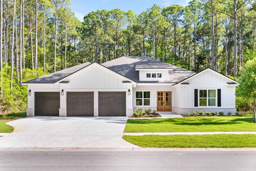 Discover modern luxury in this custom-built, new construction home tucked within the natural beauty of Steamboat Landing in Hammock Bay. Backing up to a wooded preserve and surrounded by lush landscaping, this expansive ranch-style retreat offers year-round privacy and relaxation, boasting 4,510 sqft of entertainment space with 3,363 sqft of heated/cooled living space. Blending modern convenience and timeless elegance, this 4 bedroom with a bonus room/office, 4 bath, and 3-car garage home has it all; warm champagne/bronze finishes, expert craftsmanship, detailed trim work and thoughtful design touches. Don't miss your chance to own one of the most exquisite new builds in this gated bayfront community- schedule your private tour today Featuring a gas indoor and outdoor ventless fireplace, 10ft ceilings, custom mahogany front doors, large 8x14ft glass sliding doors opening to the back patio, vast primary suite, oversize 7" cove crown molding, and a custom kitchen with a walk-in pantry, spacious island, quartz countertops, double ovens, upgraded appliances (48" wide range tope and fridge). 

Set within the master-planned community of Hammock Bay, Steamboat Landing is an exclusive enclave offering a rare waterfront lifestyle on Choctawhatchee Bay. This private, gated neighborhood features expansive homesites with luxury residences that showcase a refined coastal aesthetic and generous outdoor living spaces. Residents enjoy direct access to the bay via a scenic 500-foot pier, ideal for sunset views or launching a paddleboard. A short walk away, the new Bay Club serves as a vibrant gathering spot offering over 8,000 square feet of elevated design with wraparound porches, a cozy lounge, high-speed WiFi, and panoramic water views. Surrounded by preserved natural beauty and connected by trails, Steamboat Landing seamlessly blends serenity, luxury, and bayfront living.