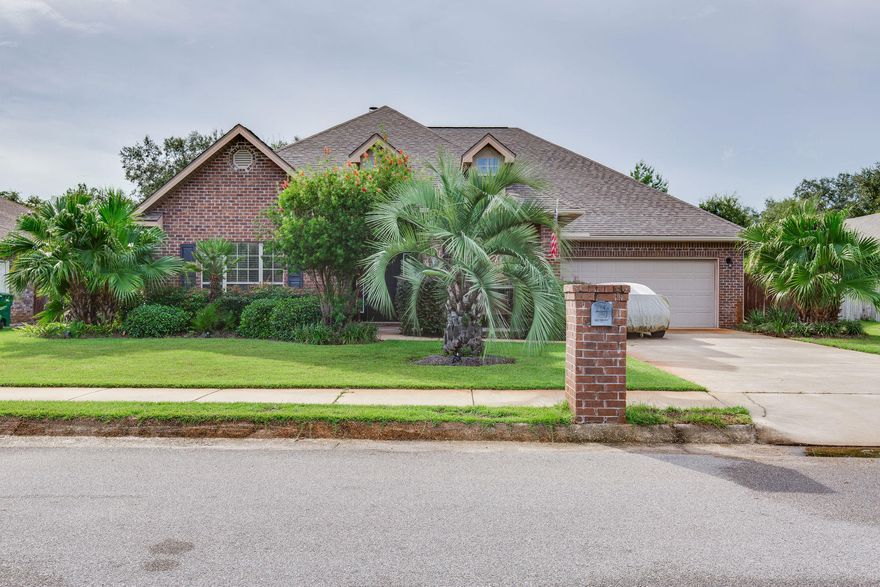 Your new place to call home in the highly sought after community of Grand Bay Estates. This exceptional family neighborhood, located minutes from Navarre Beach, has sidewalks, street lamps and resident access to the East Bay for fishing, kayaking, or just relaxing with family and friends off the community pier. This meticulously maintained 5 bed, 3 bath home, also features a dining room and an office. The spacious kitchen is equipped with granite counters, center island, and beautiful 36''recessed cabinets that offer plenty of storage. The breakfast bar overlooks living area that boast a box trey ceiling with elegant large fireplace. Tile flooring throughout the home and abundance of storage space. This stunning home also features a master suite with another box trey ceiling, crown molding and a separate entrance for quiet escapes. The master bath with double sinks, granite counter and new tiled shower is sure to please. Over sized extended patio with  motorized retractable awning  for entertaining and plenty of room for a pool with privacy fence. Wired for both indoor and outdoor audio system. Sprinkler and alarm system. Come see this fine home that shows pride of ownership.