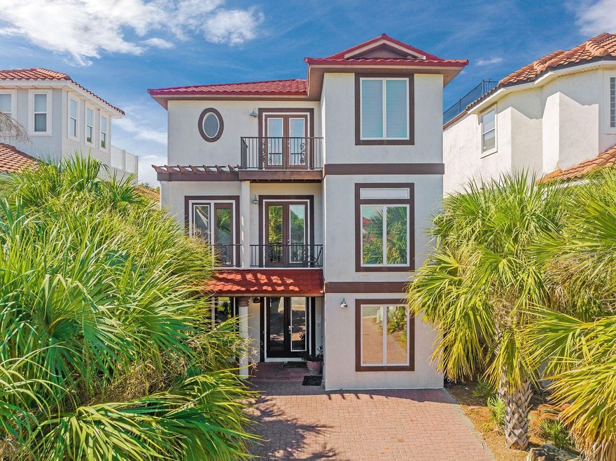 This beautifully updated three-story coastal retreat with deeded beach access offers the perfect blend of comfort, style, and investment potential in the heart of Miramar Beach. Designed with timeless Mediterranean charm, the home features a newly installed red-tile roof (October 2022) with a 50-year transferable warranty, brick paver drive, and elegant wrought-iron balconies that enhance its striking curb appeal. Inside, the home welcomes you with a relaxed yet refined coastal aesthetic, multiple spacious living areas, and a flowing layout connected by a winding wood-tread staircase- ideal for hosting and entertaining. With five well-appointed bedrooms, the home comfortably accommodates large groups, making it an exceptional vacation rental opportunity. Two expansive primary suites provide flexible living arrangements, including a first-floor suite complete with a private balcony, kitchenette, and oversized bath--perfect for guests or multi-generational stays. The main kitchen is thoughtfully designed with stainless steel appliances, granite countertops, and ample prep space, seamlessly opening to the dining and living areas for effortless gatherings. Outdoor living is just as inviting, with front and rear balconies capturing Gulf breezes and stunning sunset views. Many of the bedrooms offer private en-suite baths and balcony access, creating a sense of privacy and retreat for guests throughout the home. Offered fully furnished and turnkey, this property includes numerous recent upgrades such as a new roof (2022), HVAC system, two new water heaters, Nest thermostat, and energy-efficient tinted windows in the main living areas. Located within a gated community, residents and guests enjoy access to a resort-style pool, tennis courts, sand volleyball, and clubhouse amenities. Just a short walk away is deeded beach access along with popular local favorites like Captain Dave's On the Gulf and Kenny D's Beach Bar & Grill. A newly added neighborhood favorite, Sandos Beachside, offers a vibrant, walkable dining and bar experience--an exciting bonus for both owners and guests. Whether you're seeking a second home, income-producing rental, or a combination of both, this property delivers on location, lifestyle, and long-term value.