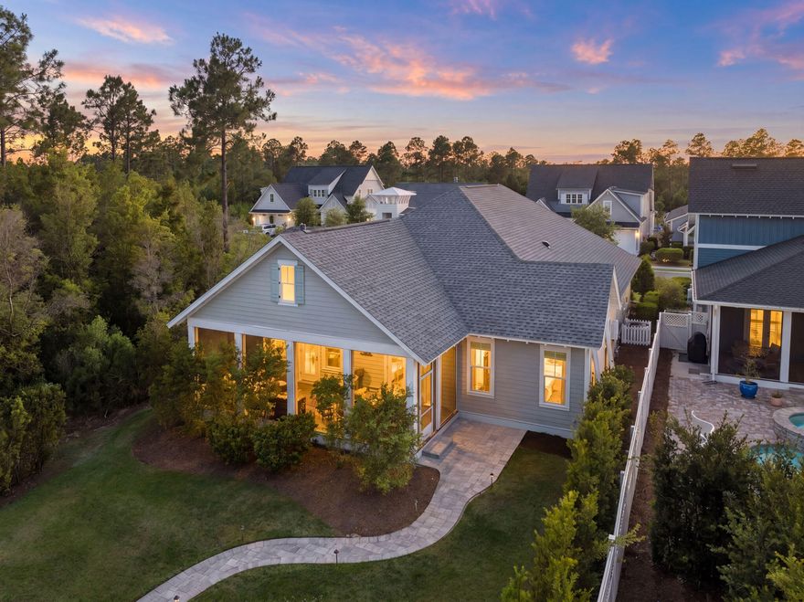 Located in WaterSound Origins, this Ficus plan built by Huff Homes, offers single-level living with over 2,500 square feet, four bedrooms, and a two-car garage, along with a series of thoughtful upgrades throughout.

The backyard is a standout feature, offering an oversized footprint with added privacy and mature, layered landscaping. Room for a pool and spa. Outdoor elements include a gas firepit, coquina shell gas fireplace, and a second set of porch doors that expand access from the main living area, creating multiple points of entry and a more connected layout.

Inside, the home features floor-to-ceiling shiplap in the living room, with additional shiplap detailing in the entry and primary bedroom. Ten-foot ceilings, crown molding, and Kingsley Medallion hardwood flooring run throughout, along with a 42-inch vented gas fireplace in the main living area.

The kitchen is equipped with stacked glass cabinetry with accent lighting, undercabinet lighting, a 36-inch Wolf range, and a 36-inch Sub-Zero built-in refrigerator.

Additional features include a gas lantern at the front porch, a stub for a gas grill with poured pad, security camera outlets, and an outdoor shower located adjacent to the garage, along with added exterior access at the garage for convenience.

A well-maintained home with a functional layout, elevated finishes, and a rare backyard setting within WaterSound Origins.
