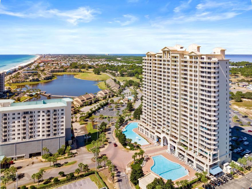 Perched on the 15th floor of Ariel Dunes I, this beautifully furnished two-bedroom, two-bath condominium captures some of the most expansive water views in the area, offering sweeping panoramas of both the Gulf of America and Choctawhatchee Bay. Positioned high above neighboring buildings, the residence enjoys a unique vantage point that allows uninterrupted views over Majestic Sun, creating a striking coastal backdrop from sunrise to sunset.  

Inside, the thoughtfully arranged floor plan comfortably accommodates up to six guests and blends everyday comfort with vacation-ready style. The primary suite features a king bed, private ensuite bathroom, and direct access to the balcony, where the sound of the surf and wide-open gulf views become part of the daily routine. A queen bedroom and an additional full bath provide welcoming accommodations for guests, while the spacious living area offers plenty of room to unwind after a day at the beach. The fully equipped kitchen and dedicated laundry room add convenience for extended stays or rental guests. 

Step outside onto the private balcony and take in the sweeping coastal scenery that defines life along the Emerald Coast. Whether enjoying morning coffee as the sun rises over the water or relaxing in the evening as the sky turns shades of pink and gold, this elevated perspective is one of the property's most memorable features. 

This residence has also proven to be a strong income-producing investment, currently operating as a short-term rental with professional management and generating approximately $27,000 annually. The property conveys fully furnished, including balcony furnishings, making it ready for immediate enjoyment or continued rental use. 

Residents enjoy access to the extensive amenities of the Seascape resort community, including private deeded beach access, a championship golf course, on-site dining, and convenient shopping within the resort grounds. Ariel Dunes I itself offers resort-style amenities, including a large zero-entry pool, fitness center, and beautifully maintained grounds, enhancing the coastal lifestyle. 

Beyond the resort, Miramar Beach places you within minutes of some of the Emerald Coast's most popular destinations. Silver Sands Premium Outlets offers more than 100 designer stores and dining options nearby, while beachfront favorites like Whale's Tail and Pompano Joe's are within easy reach. The nearby Village of Baytowne Wharf and Grand Boulevard add even more entertainment, restaurants, and shopping just a short drive away.