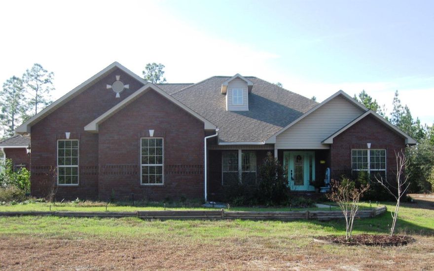 NEW PRICE! Elegant big city house in a private country setting! 3300 sqft brick home on 3.42 acres. Long private drive. Lovely foyer opens to Great Room with vaulted ceiling, Office, Dining Room. Fabulous Kitchen with island, granite, stainless, wood cabinets, tons of counter space, and adjoining Breakfast Room. Split Bedroom plan with Master Suite on one side, 3 Bedrooms and Guest Bath on the other. 2nd floor Bonus Room with 1/2 bath could be media room, rec room, other. Front and side yards are cleared to edge of woods. Back yard is a wonderland of pergolas and walkways with fire pit, fountain, bird feeders, and gardens, separated by picket fence from surrounding woods. 3 outbuildings include greenhouse with potting bench, water, and rooftop deck! See additional info at MORE and photos. This is an amazing property, with more features than can be described in the remarks section, so please read on and also see the photos for more details.  

From the front porch one enters the foyer, with an office/study on the right and a formal dining room to the left, all with hardwood floors.  The foyer opens to the great room, with an approximately 16' vaulted ceiling, and windows overlooking the rear covered patio and yard. 

The large master bedroom has a trey ceiling, and the master bath includes a jetted tub, double vanity, separate shower with three shower heads, water closet, and large walk-in closet.  

There are closets galore in this house and ample storage space including the attic.  Walls and ceilings are Spanish lace throughout, with bull-nose corners.  

The back door opens to a covered porch, which leads to the backyard wonderland.  Beyond the cleared and fenced area, woods surround the house, complete with walking/golf cart/atv paths and another wonderland, with rabbit, deer, and other wildlife.

Zoning is RR1, low density rural residential.

Access is via private roadway through two deeded easements, with a road maintenance agreement in place for the owner of this property.  See Documents section in MLS or refer to Santa Rosa County OR Book 3253 pages 1247-1253.  

Call today for an appointment to see this amazing property!