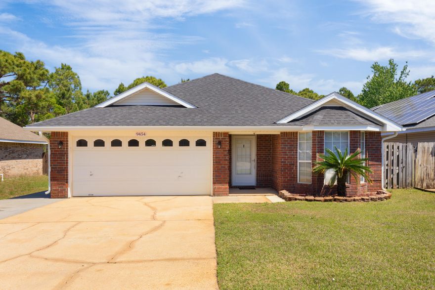 Move-in ready home in Navarre! Beautiful 3 BR/ 2 BA situated in Whisperwoods subdivision with no HOA! Wood look flooring in all common areas of the home. Expanded driveway offers additional parking accommodations for extra vehicle/boat/trailer. Floor plan large open living area. Primary suite features a large walk-in closet and en suite bath with double vanities and beautiful shower. Additional bedrooms share the second bathroom, complete with garden tub/shower. The backyard backs up to a wooded area, is encompassed by privacy fence, and includes a storage building plus a well and sprinkler system to maintain the grass. The neighborhood includes sidewalks, street lights and underground utilities. Convenient access to Hurlburt, Eglin, NAS, schools, and beaches. Roof replaced July 2019.