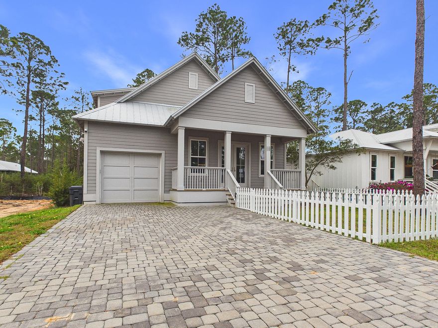 Discover coastal charm and modern luxury in this stunning Point Washington cottage, located in a premier community of full-time residents just minutes from the beaches of South Walton. A brick paver driveway and inviting front porch welcome you into a light-filled interior featuring durable luxury vinyl plank flooring and an open floor plan. The chef-inspired kitchen is a true highlight, boasting quartz countertops, shaker-style cabinetry, and upgraded stainless steel appliances including a gas range with a professional pot filler. The main-level primary suite offers a private retreat with a spa-like bath, while a whole-home water filtration system and a built-in workstation add everyday convenience. Designed for the quintessential Florida lifestyle, the exterior living spaces are perfect for entertaining. Host summer cookouts on the expansive screened back porch, which features a fully equipped outdoor kitchen and grill area. The property is beautifully enclosed by a new white picket fence and includes a dedicated dog run for pet owners. Ideally located a short walk from Bay access, this home is perfect for those looking to live, work, and play near 30A. Whether you are seeking a primary residence or an investment, this property delivers, with rental projections available upon request.