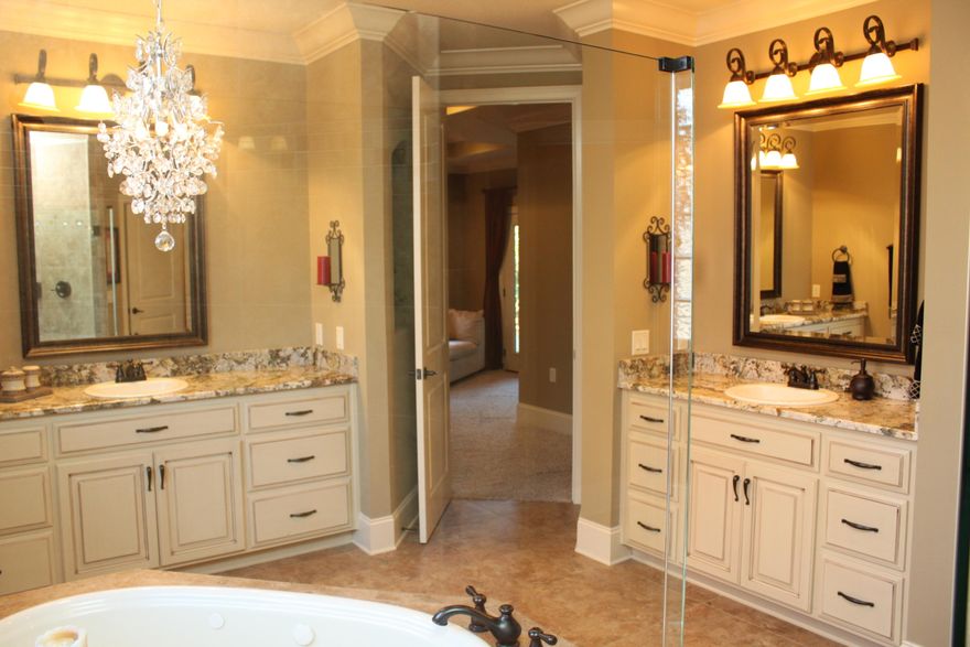 Welcome to the most extravagant home in Heritage Park. This eye catching home features a desirable floor plan that was custom designed by the award winning Robbins Builders. Priced so attractively for the detail and security of this beloved neighborhood. 5th bedroom would be great for a den or office.
Tall ceilings, earth tone pallet, triple crown molding, and attention to detail. Not your standard home.... come see why this is a rare deal. Come make your memories here at one of the finest & newest year built homes available.