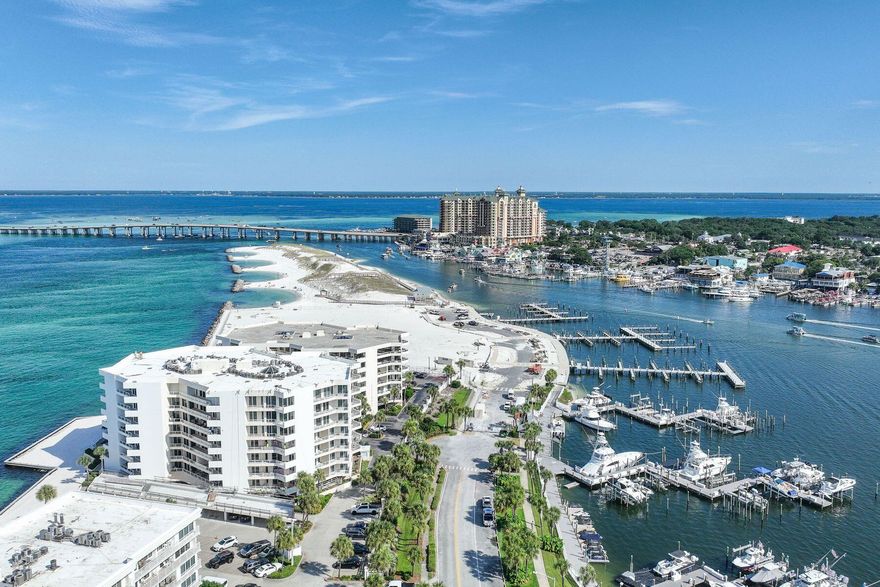 Three Month Minimum Rental Period. Dedicated Garage Parking Spot and Storage. SIRS complete and all assessments paid. Two Master Suites. Beach or boater's delight. Gulf, East Pass and harbor views. Fireworks, air shows and incredible night light views from an expansive balcony. Perched on the sixth floor at the very tip of Holiday Isle, this gracious residence offers panoramic views that sweep from the Destin Harbor to the sparkling gulf waters of the East Pass. Walls of floor-to-ceiling glass and a generous balcony that spans the full width of the unit invite both sunlight and sea breezes into nearly every corner, creating a serene waterfront sanctuary. The spacious layout unfolds with ease, offering a large living and dining area that is seamlessly connected to a well-appointed kitchen, complete with granite countertops, stainless steel appliances, a generous bar, stainless steel appliances, a generous bar, and a dedicated wine bar, all designed for effortless entertaining. Two private master suites, each with its own ensuite bath, provide luxurious accommodations for owners and guests alike, while a third bedroom and full bath offer additional flexibility. Resort-style amenities elevate everyday living, featuring an exclusive owners-only seasonally heated pool, hot tub, fitness center with sauna, a club room for events, as well as a private stretch of white-sand beach. A covered garage space right by the elevator entrance and dedicated storage room add convenience. A private marina just across the street offers deep-water boat slips for sale, for boaters who want to enjoy Destin's famed waterways. No boat, no worries, as you can call the boat taxi to pick you up at the East Pass Marina dock for quick trip across the water to award winning, boat-to-table seafood restaurants and night life on the harbor.  East Pass Towers II is a secure, gated building renowned for its quiet, residential atmosphere with a 3-month minimum rental period. Featuring thoughtful updates, the condo association has proactively nearly completed all needed maintenance and improvements and all assessments have been paid by the seller. From fireworks and air shows on summer nights to tranquil mornings watching boats or dolphins glide by, this is waterfront living at its finest. Destin Executive Airport is just 2.3 miles away for all the pilots wanting to escape the beach or if you prefer charter services. Next to East Pass Towers and nearing completion of improvements is Norriego Point Beach Access and Park where, according to the City of Destin website, will include ADA accessible restrooms, showers, drinking fountains, environmental educational signage, bike racks, boardwalk, dune crossovers, and vehicle parking.