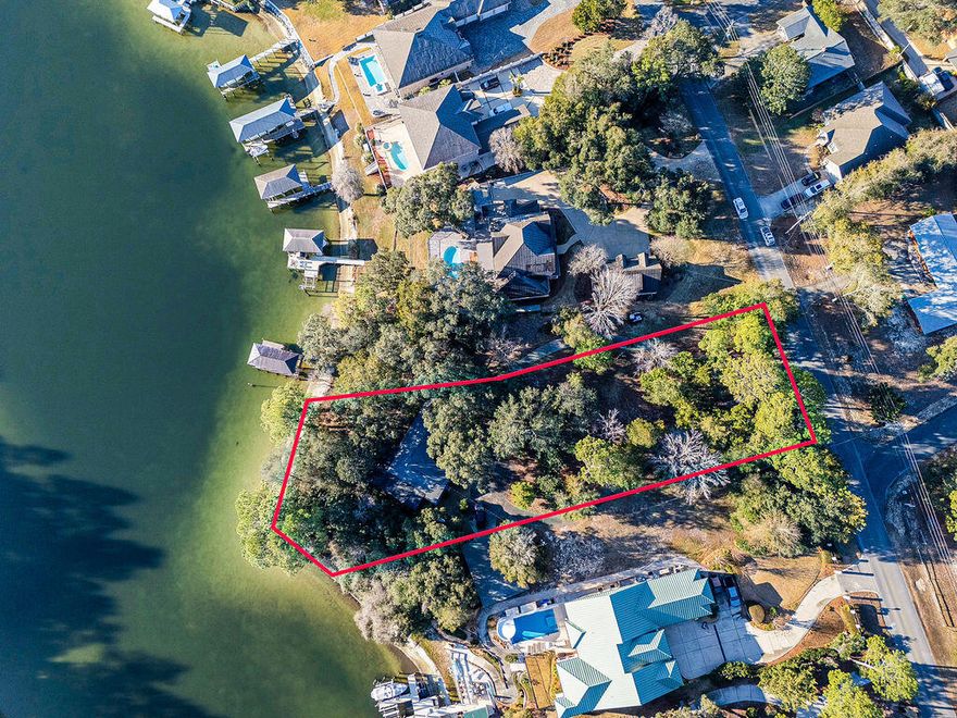 2 Adjoining Lots, 1.3 acres, 230 waterfront feet on a peninsula! For the first time in over half a century, this coveted, multi-generational property in Poquito Bayou is available to the public. This is not just a lot; it is a sanctuary. Spanning a massive .8 acres with over 145 feet of waterfront, this parcel sits on a rare, protected bluff. This elevation offers peace of mind few waterfront owners possess: No flood insurance is required.

While the rest of the world rushes by, life here moves at the pace of the tide. The deep waters of the bayou are legendary for their calm, protected nature--even during rough weather. You can kayak or paddleboard nearly 365 days a year, paddling out to watch dolphins corral fish for breakfast or spotting a manatee gliding through the glass-like surface. Your view? A pristine natural forest across the water--no neighbors looking back at you.Just you, the jumping mullet, and the bald eagles and ospreys hunting at sunrise. This is the rarest of opportunities to secure a high-and-dry, deep-water estate that has been held tight by one family for five decades. Don't let another decade slip by dreaming about it. (Individual Lot Sales-MLS: 994271 & 1002259)