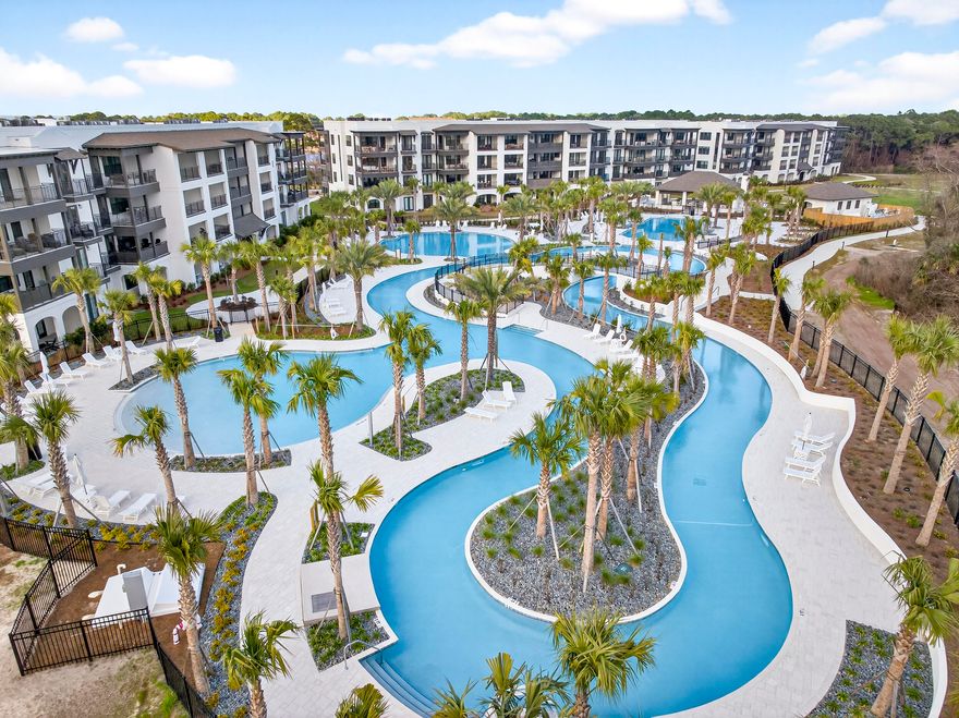 Welcome to luxury coastal living at its finest! This brand new construction condo offers nearly 2,400 square feet of thoughtfully designed space, featuring 4 spacious bedrooms and 4.5 baths, each bedroom with its own private ensuite for ultimate comfort and privacy.

Step inside to find 9 foot ceilings, luxury vinyl plank flooring, quartz countertops, soft close cabinetry, gas range, and high end Bosch appliances throughout the kitchen. Designer touches like decorative barn doors add character, oversized closets, abundant storage included. The unit comes fully furnished and includes a washer and dryer, making it truly turnkey.

Enjoy seamless indoor outdoor living with an oversized balcony overlooking the stunning tropical pools, lazy river, and swaying palm trees. Ideally located right next to the pool, this condo offers one of the best spots in the community.   The Mediterranean style building features elevators for convenience, along with beautifully designed pavilions complete with glass fireplaces, gas grills, and inviting lounge and picnic areas. Cocktails and food service at the pool, launching this summer.  Short term rentals are allowed.  Owners and guests enjoy access to all the amenities at The Grove and Seascape Resort, including golf, tennis, pickleball, and 2,000 feet of pristine beach.  Many restaurants onsite including 2 Birds, ACME Oyster House, Mezcal and the popular beach front Whale's Tail  restaurant.