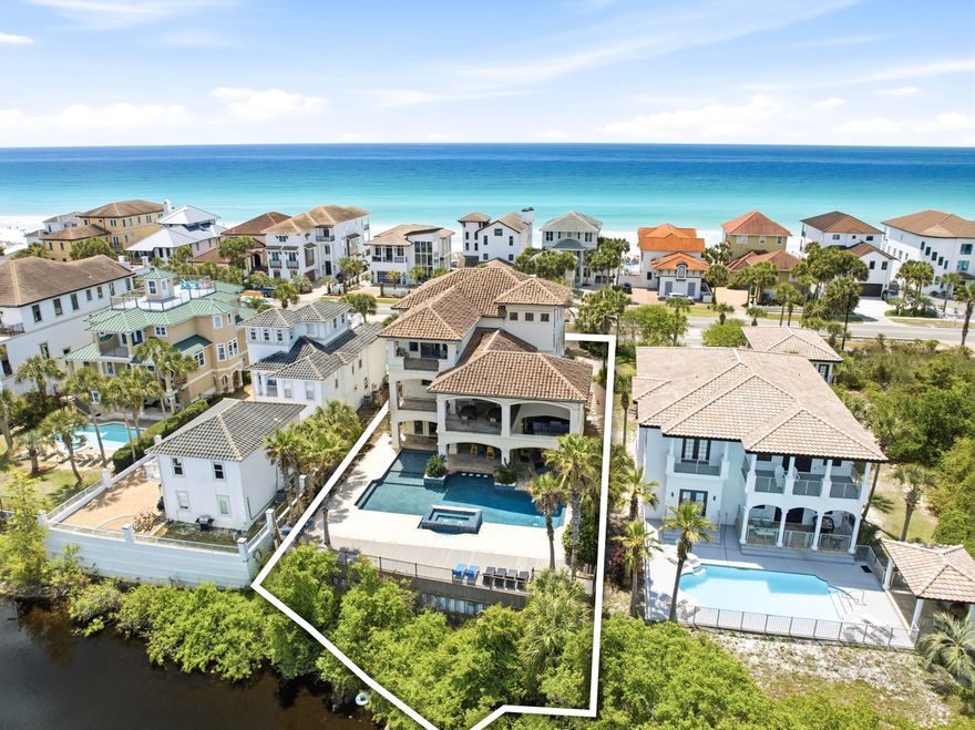 Welcome to an exceptional beachside retreat in the heart of Destin, where coastal luxury meets effortless income potential. Perfectly positioned with 61 feet of lake frontage and sweeping Gulf views, this remarkable residence is just steps from the sugar-white sands of the Gulf of Mexico and a short stroll to a sprawling beach access. The first level is designed for recreation and seamless indoor-outdoor living, featuring a spacious game room complete with a pool table, arcade games, and a convenient kitchenette with full-size refrigerator and ice maker. Multiple guest suites and bunk accommodations offer flexibility for large groups, while direct access leads to a true backyard oasis. The outdoor space lives like a private resort, highlighted by a beautifully designed pool with Baja shelf and spa, expansive sundeck, and tranquil lake views. A covered outdoor living area with a full kitchen, grill, beverage cooler, fireplace, and mounted TV creates the perfect setting for entertaining or unwinding after a day at the beach. A thoughtful feature includes an elevator servicing all three levels. The second level serves as the heart of the home, where an open-concept layout seamlessly connects the kitchen, dining, and living areas. A chef's kitchen anchored by an oversized island and premium appliances flows into a grand dining space accented with vaulted Pecky cypress ceilings and designer lighting, ideal for hosting large gatherings. The living room is filled with natural light and opens to a spacious balcony overlooking the pool and lake with direct access to the pool deck, adding convenience and extending the living space outdoors. Additional guest suites on this level provide comfort and privacy, with select rooms offering private balcony access. The third level offers a more private retreat with an additional living area and multiple well-appointed king suites, each with en suite baths. Select bedrooms feature soaking tubs and private balconies capturing glimpses of the Gulf, while additional bunk accommodations ensure ample space for guests. At the top, a rooftop viewing deck provides a breathtaking vantage point, where sunsets over the Gulf create an unforgettable daily experience. Offered fully furnished and turnkey, this expansive residence comfortably accommodates up to 28 guests and is ideally suited as both a legacy second home and a high-performing short-term rental. This is a rare opportunity to own a property that truly captures the essence of Destin living, blending scale, luxury, and an unbeatable location into one extraordinary offering.