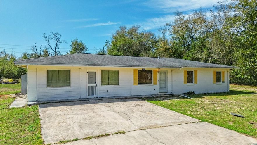 No HOA, 1 Acre of land, 4 bed 2.5 bath, block home!!! Discover the perfect blend of modern living and rural freedom in this well-maintained concrete block home, nestled on a peaceful, wooded one-acre lot in the heart of Bayou George. With no HOA restrictions, this property offers true independence, featuring a cleared area around the home ideal for parking boats or RVs, complemented by a back concrete patio and separate outbuildings for all your storage needs. The spacious 1,664+ square foot interior boasts an open-concept layout with four bedrooms, 2.5 bathrooms, and attractive hardwood-look tile flooring throughout. The chef-ready kitchen is equipped with a gas range, stainless steel appliances, and stylish barn doors, while a generous walk-in laundry room and gas tankless water heater add modern convenience. Key high-value extras include a private deep well with a Culligan water softener, a 250-gallon in-ground propane tank, and an active AC maintenance agreement with Peaden for added peace of mind. Located just a short drive from the boat ramps at Deer Point Lake and the amenities of Panama City via Highway 231, this move-in-ready gem is the ideal sanctuary for those seeking a wooded retreat with city accessibility. Schedule your showing today!