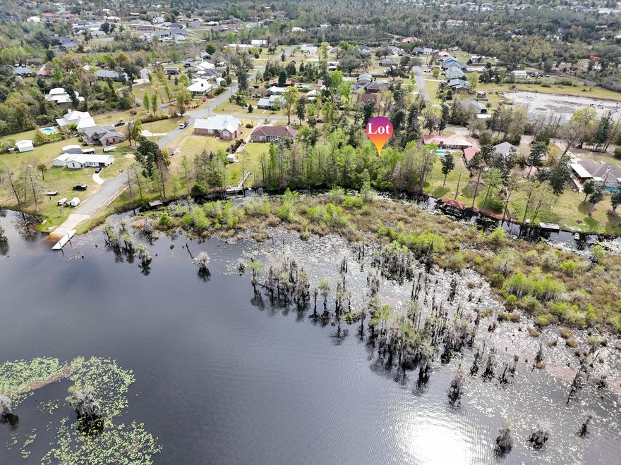 Build your dream retreat on this exceptional 0.57-acre canal-front homesite offering 100 feet of water frontage with direct access to Deer Point Lake. With serene water views & ample space to design your ideal residence, this property provides the perfect setting for a private dock, pool, workshop, or additional outdoor living features. Deer Point Lake is a 5,000-acre freshwater reservoir, formed by damming Econfina Creek, Bear Creek, and Cedar Creek, and is widely known for its outstanding fishing, boating, kayaking, and paddle boarding. Whether you envision a full-time residence or a peaceful weekend escape, this location delivers both recreation & tranquility. Conveniently situated approx 150 yards from the public boat ramp at Cedar Creek, water access is effortless. For those seeking even more space & expanded waterfront, the adjacent lot is also available, presenting a rare opportunity to own a combined 1.15 acres with 200 feet of canal frontage. This prime homesite makes an exceptional canvas for your waterfront vision with direct lake access, generous acreage, and expansion potential.