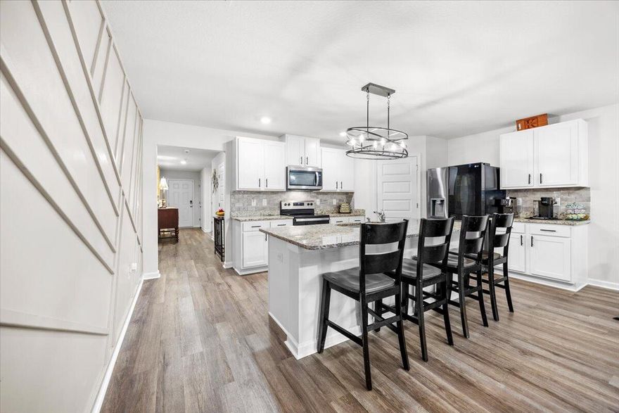 Discover this beautifully updated 2023 Craftsman-style home located in the heart of East Milton. Featuring 4 bedrooms and 2 baths, this residence blends modern design with timeless character, offering both style and function for today's lifestyle. As you step inside.. an open-concept living area bathed in natural light, enhanced by contemporary finishes and an eye-catching Art Deco painted feature wall adding personality and elegance to your living space. The kitchen is a chef's delight, showcasing granite countertops, sleek cabinetry, a spacious island, and matching granite surfaces in all wet areas. Whether you're preparing dinner or hosting guests, this space is designed to impress. Every window has been fitted with 2-inch faux wood blinds, providing privacy, light control, and a polished touch throughout the home. The primary suite offers a serene retreat with ample space, a walk-in closet, and a spa-inspired ensuite. The property also boasts a fully fenced-in backyard for your outdoor privacy, children and pets.